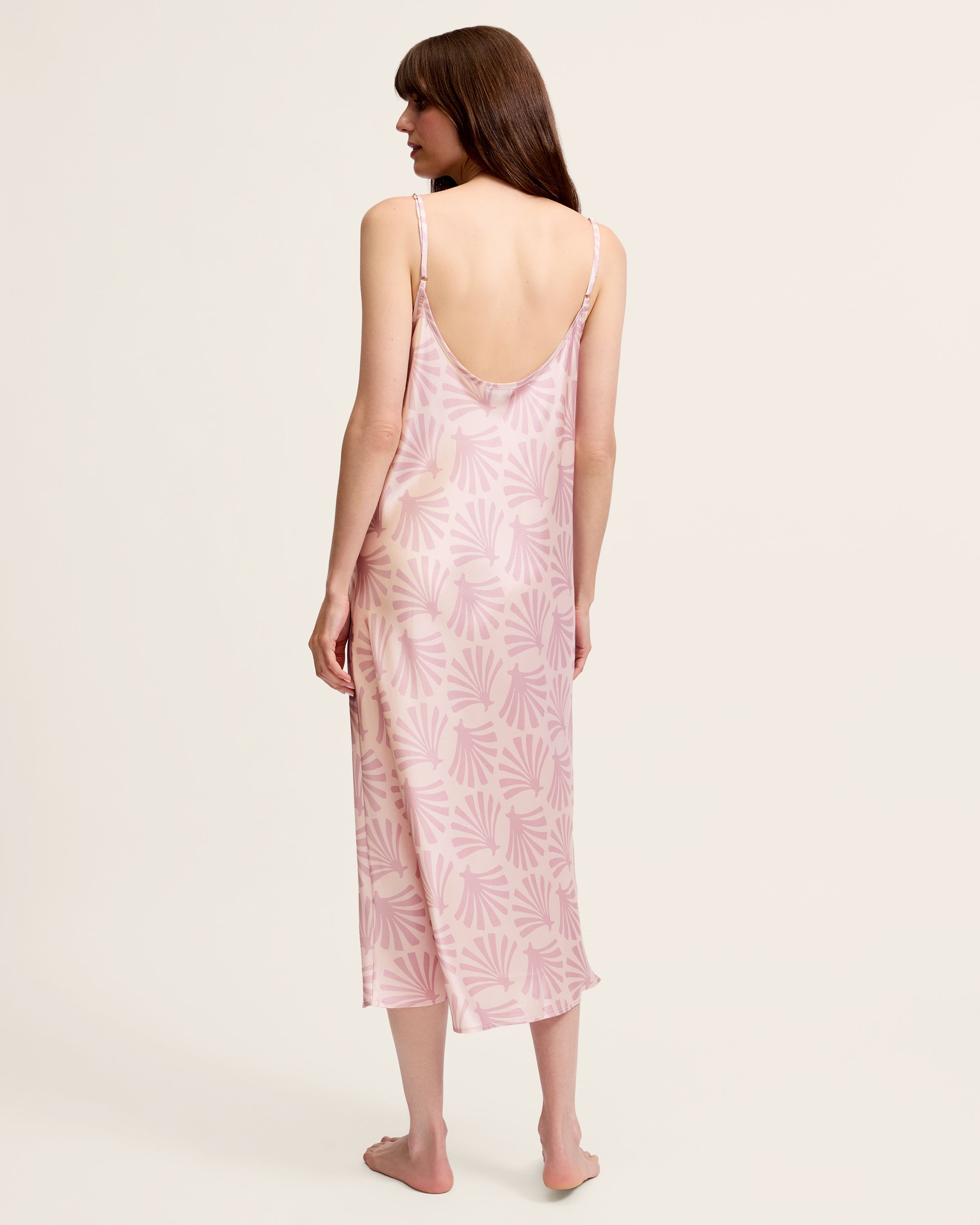 The Women's Silk Cosette Nightgown in Blush Tide is a light pink sleeveless slip dress with thin straps and a subtle darker pink leaf pattern, shown laid flat on a white background.