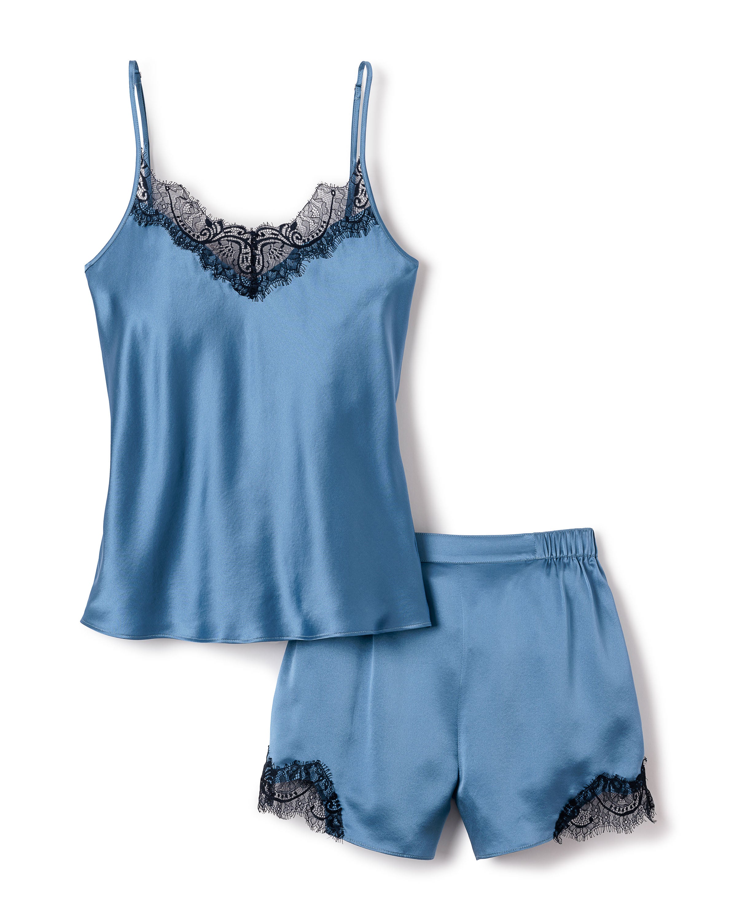 The Petite Plume Womens Silk Lace Cami Short Set in Mystique Blue features a luxurious satin camisole with adjustable straps and black floral lace along the neckline, complemented by elastic waistband shorts for a sophisticated and comfortable sleepwear ensemble.