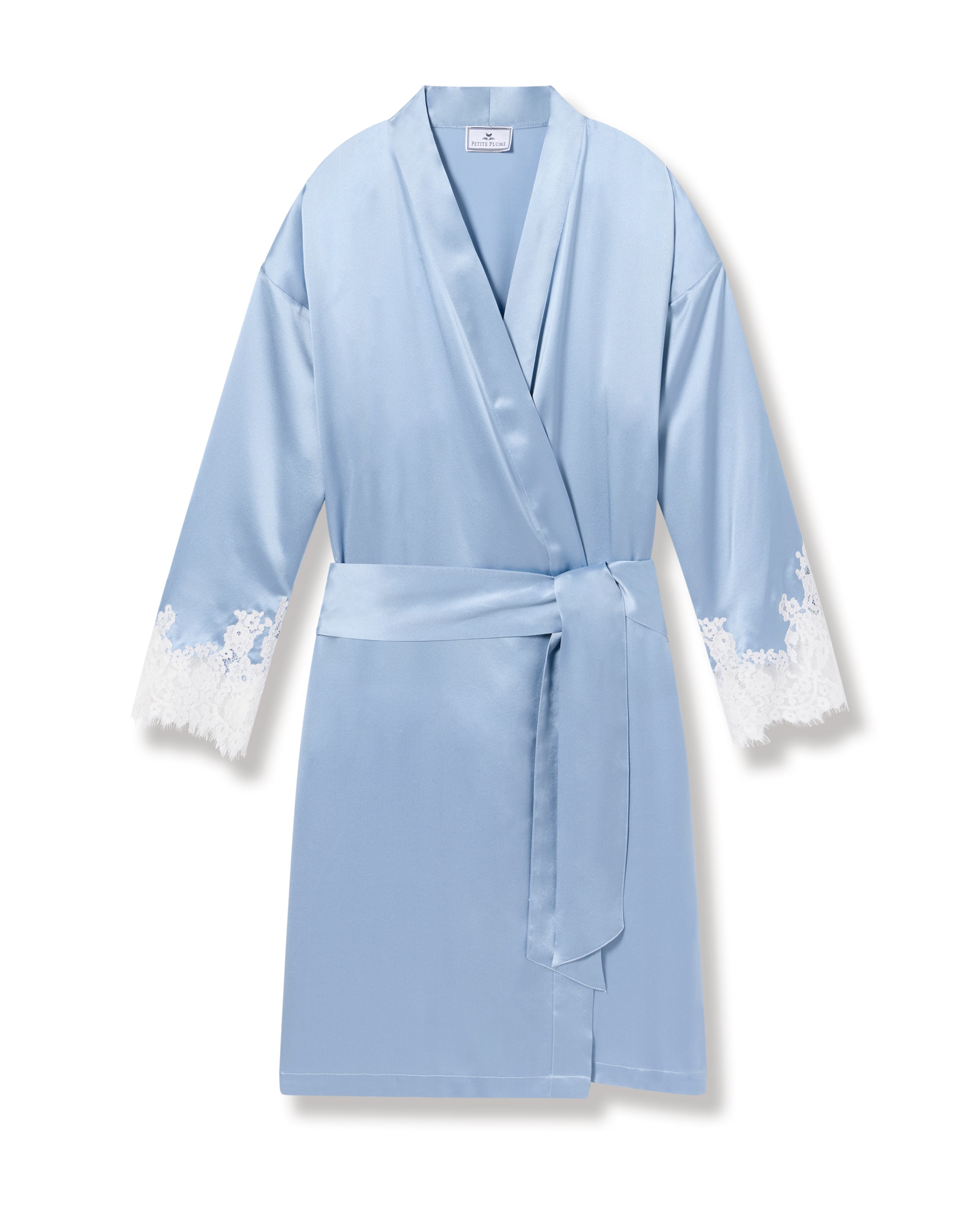 The Womens Silk Lace Robe in Periwinkle by Petite Plume is crafted from hypoallergenic Mulberry Silk. It features a wrap design with a matching belt and elegant white lace-trimmed cuffs, offering a luxurious touch to this exquisite piece of sleepwear.