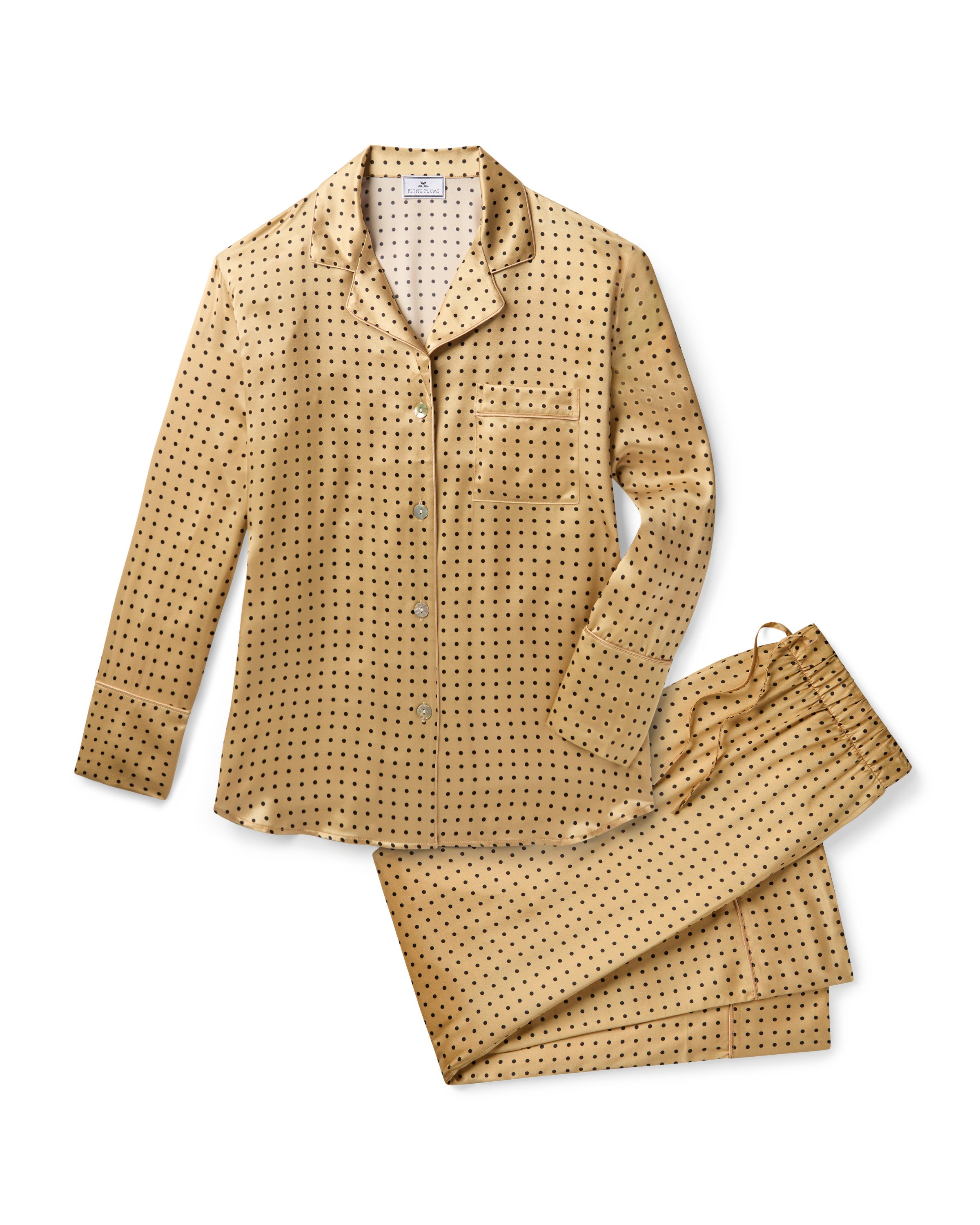 The Women's Silk Pajama Set features a gold fabric with black polka dots, including a long-sleeve button-up top with chest pocket and matching drawstring pants.
