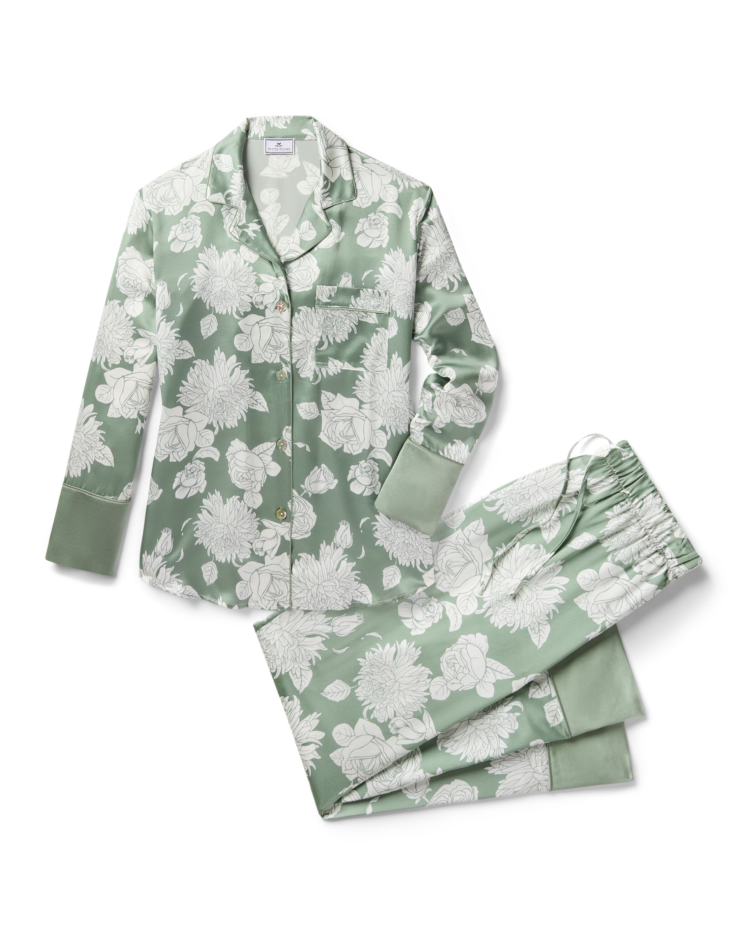 Women's Silk Pajama Set in Sage Bloom: a sage green satin set with a white floral pattern, featuring a long-sleeve button-up top with chest pocket and matching drawstring pants.