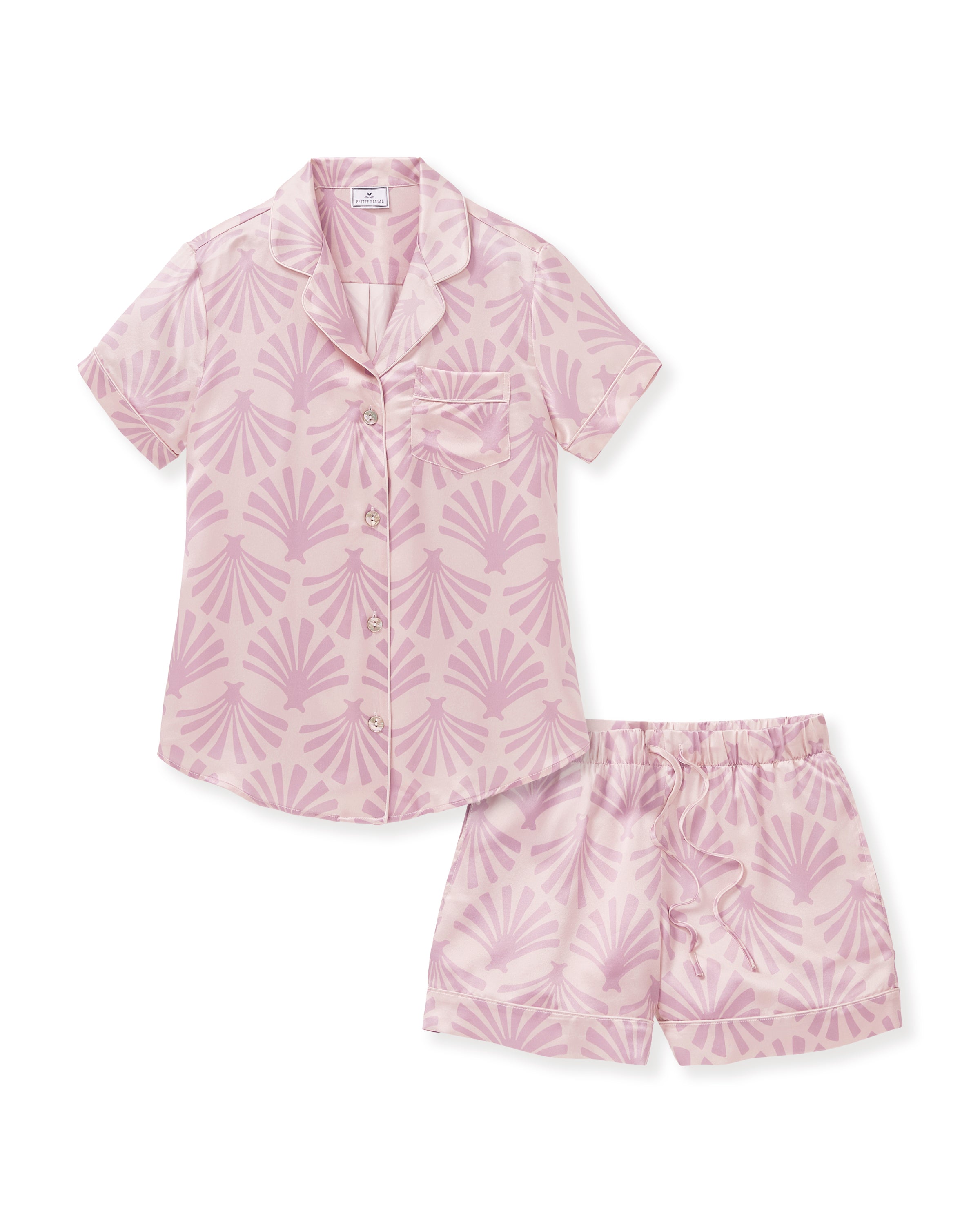 The Women's Silk Short Sleeve Short Set in Blush Tide features a matching pink button-up top and elastic-waist shorts, both adorned with a light purple geometric fan pattern.