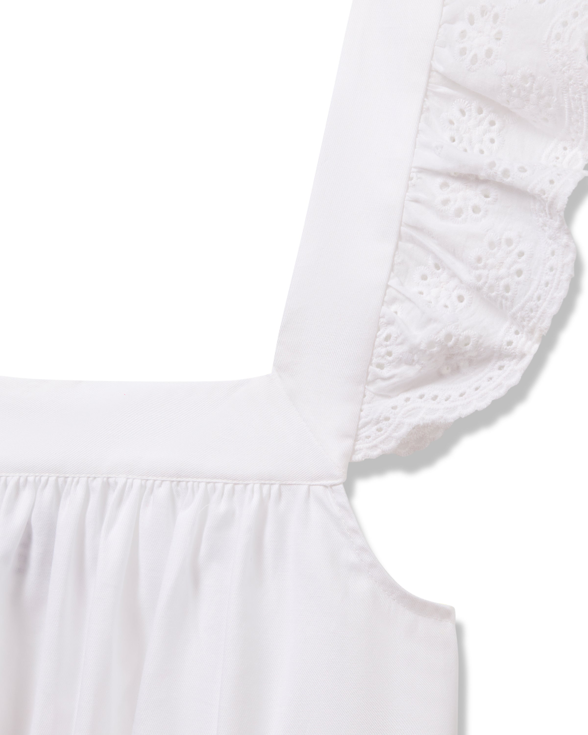 Close-up of the Womens Twill Clara Nightgown in White by Petite Plume, highlighting its luxurious essence with wide straps, ruffled floral-patterned lace trim, and high-quality cotton. The lightweight design showcases exquisite stitching and texture details.
