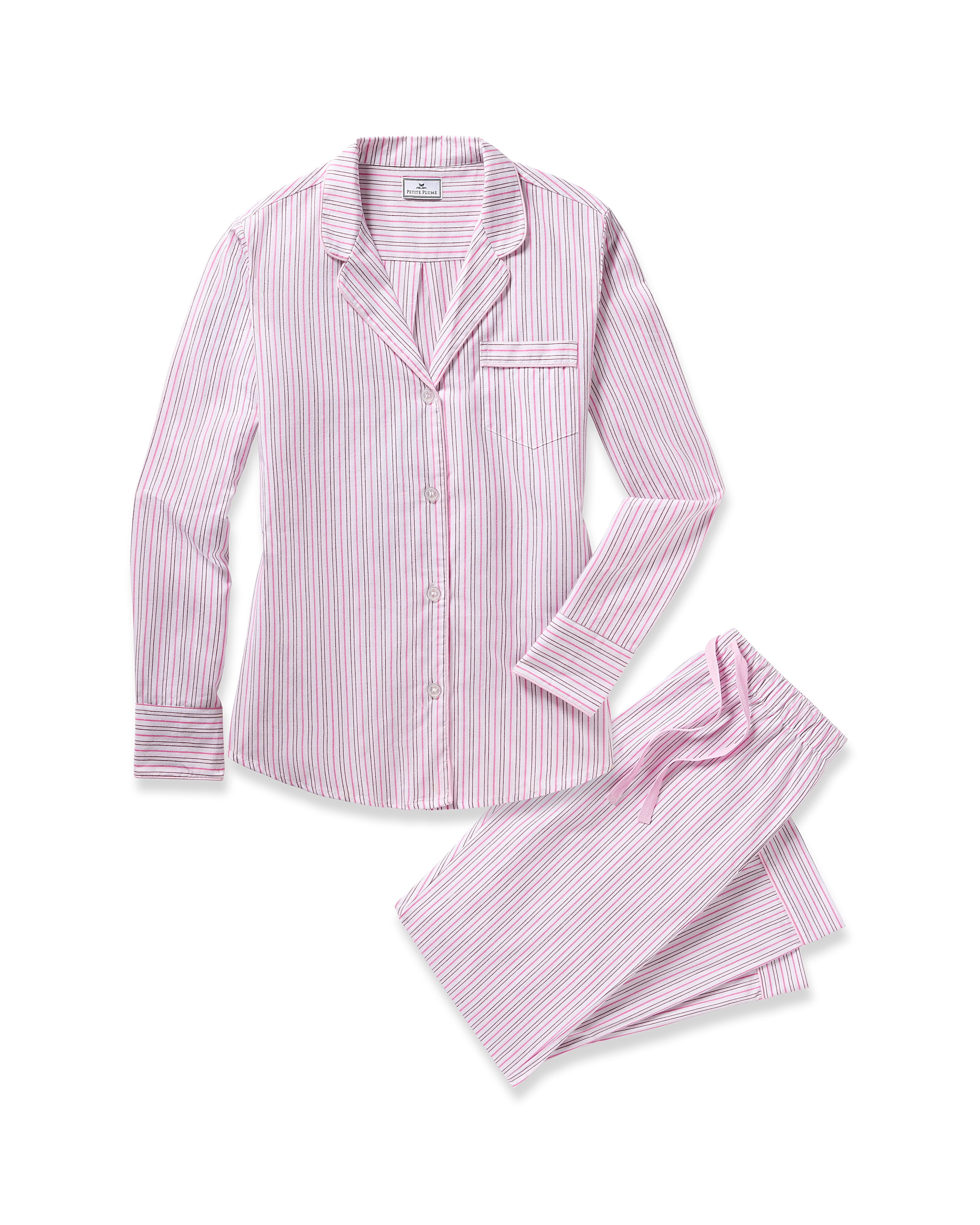 The Womens Twill Pajama Set in Blush Boulevard by Petite Plume is made from 100% cotton and includes a long-sleeve button-up shirt with a collar, chest pocket, and matching pants. Both pieces feature pink and white stripes, offering a luxurious sleepwear experience.