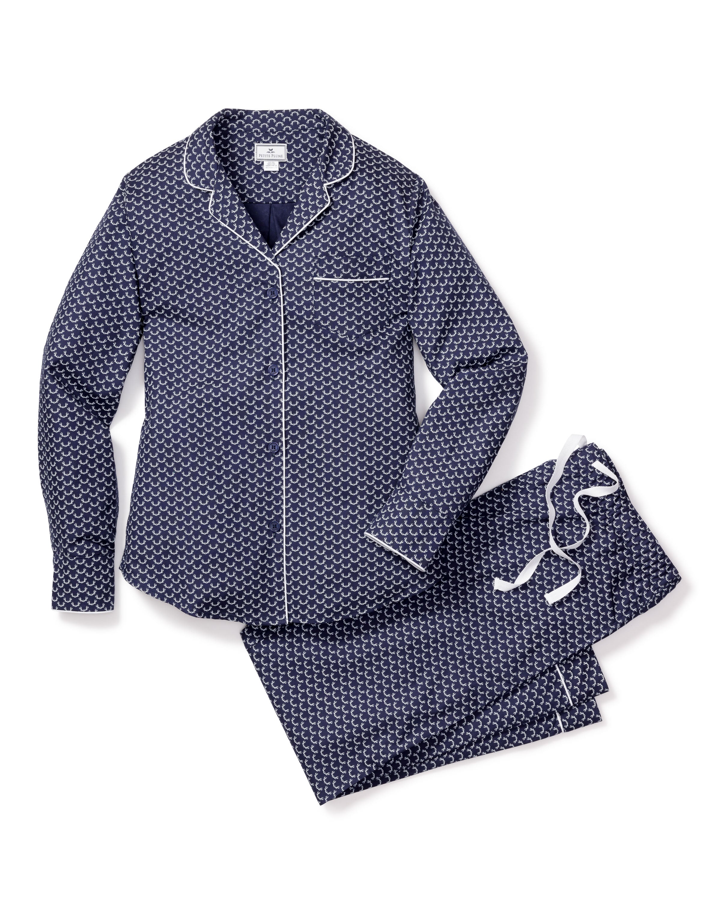 Petite Plumes Womens Twill Pajama Set in Nordic Antlers is a two-piece made from breathable cotton twill. It includes a long-sleeve, button-up top and pants in dark blue with white geometric patterns, enhanced by white piping and a drawstring, offering comfort with moisture-wicking features.