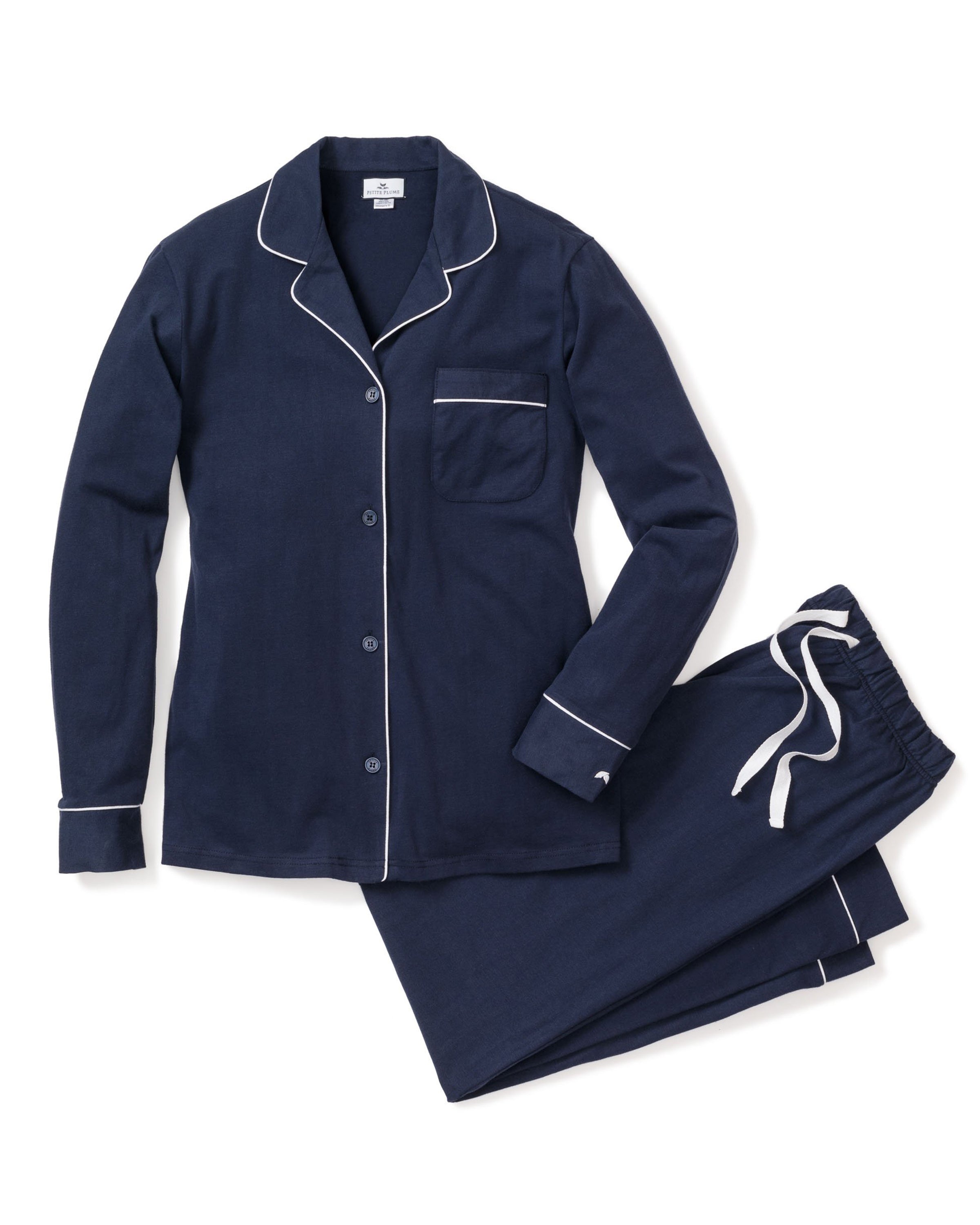 The Womens Flannel Pajama Set in Navy by Petite Plume features a long-sleeve button-up top with white piping and chest pocket, plus matching pants with an adjustable drawstring waist. Made from soft cotton twill, its perfect for cozy nights in.