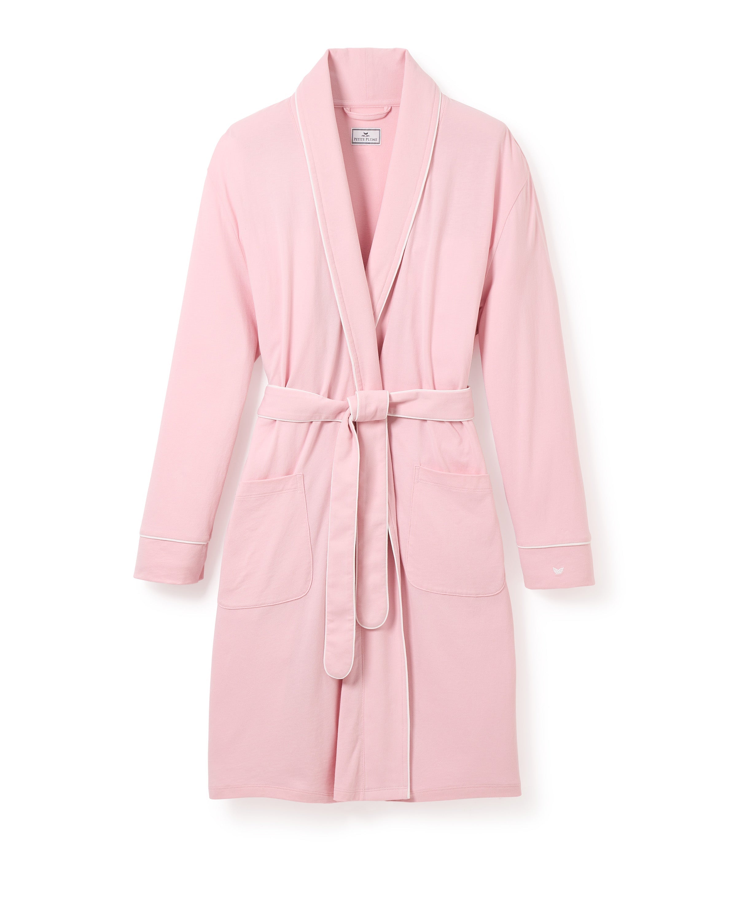 The Womens Pima Robe in Pink by Petite Plume is a soft, breathable robe with long sleeves, a shawl collar, and a matching waist belt. Luxurious yet practical, it features two large front pockets hanging against a white background.