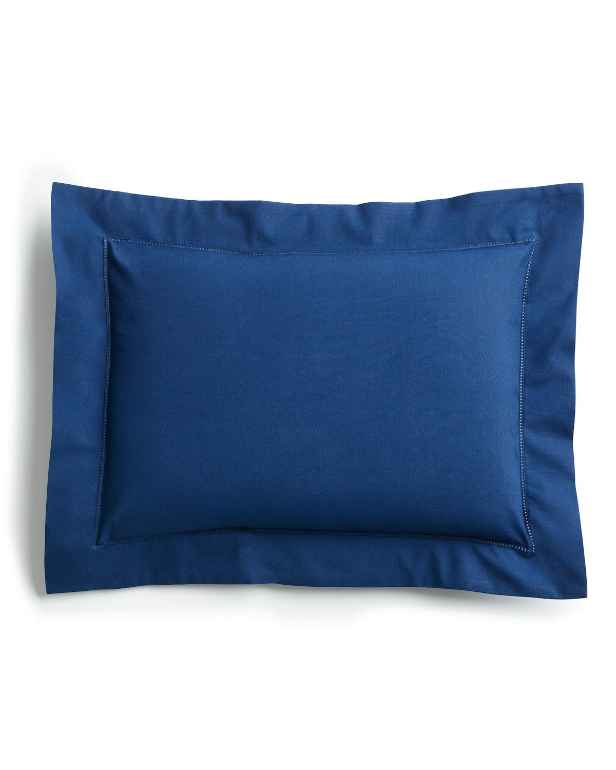 The Decorative Pillow in Navy by Petite Plume, with a darker bordered edge, crafted from luxurious percale fabric, rests elegantly on a plain white background.