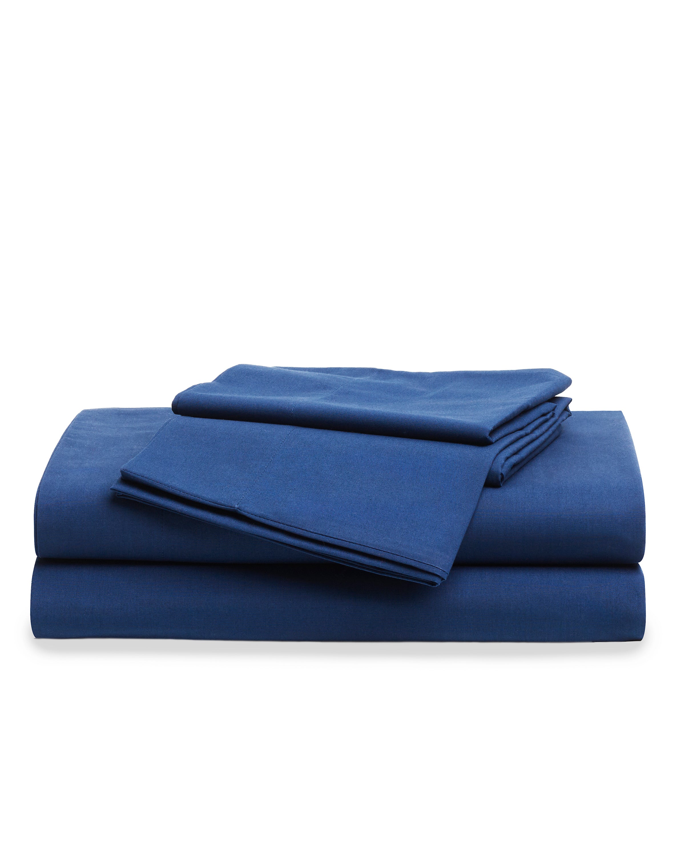 A stack of Luxe Premium Cotton Bed Sheets in Navy by Petite Plume, crafted from long-staple cotton, sits elegantly folded against a crisp white background.