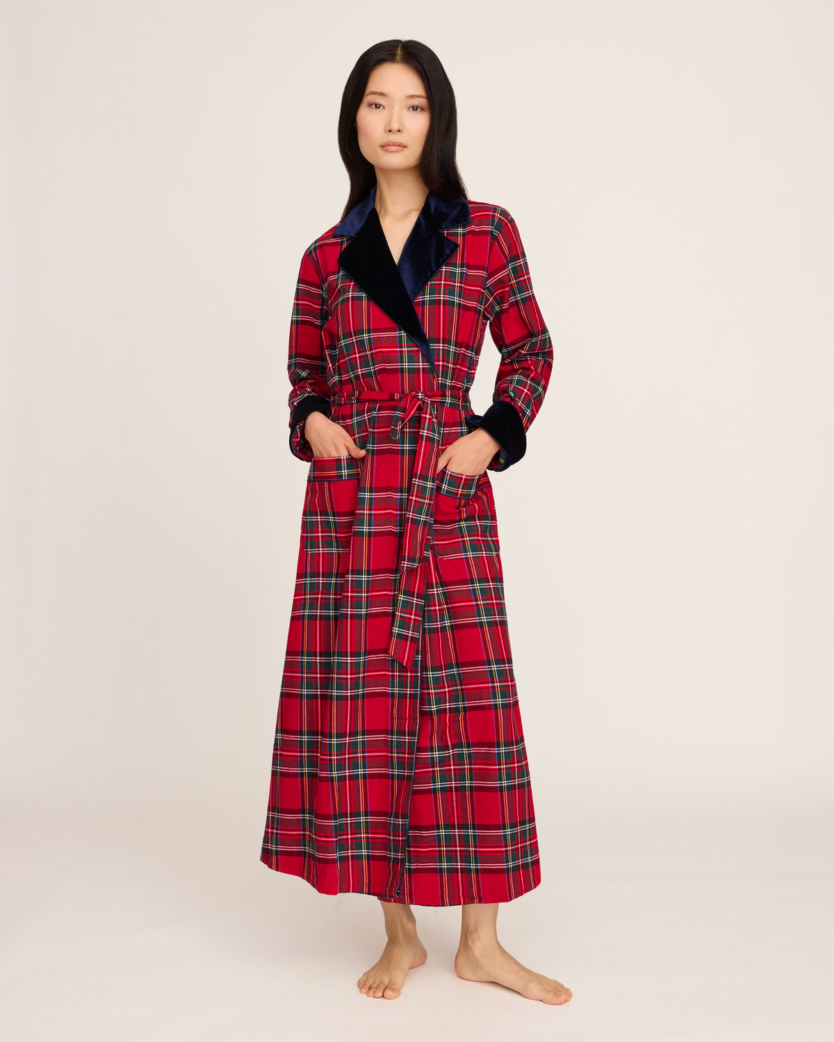 The Women's Long Robe with Velvet Trim in Imperial Tartan features a red plaid pattern, navy blue velvet collar and cuffs, matching belt, and two front pockets, displayed flat on a white background.