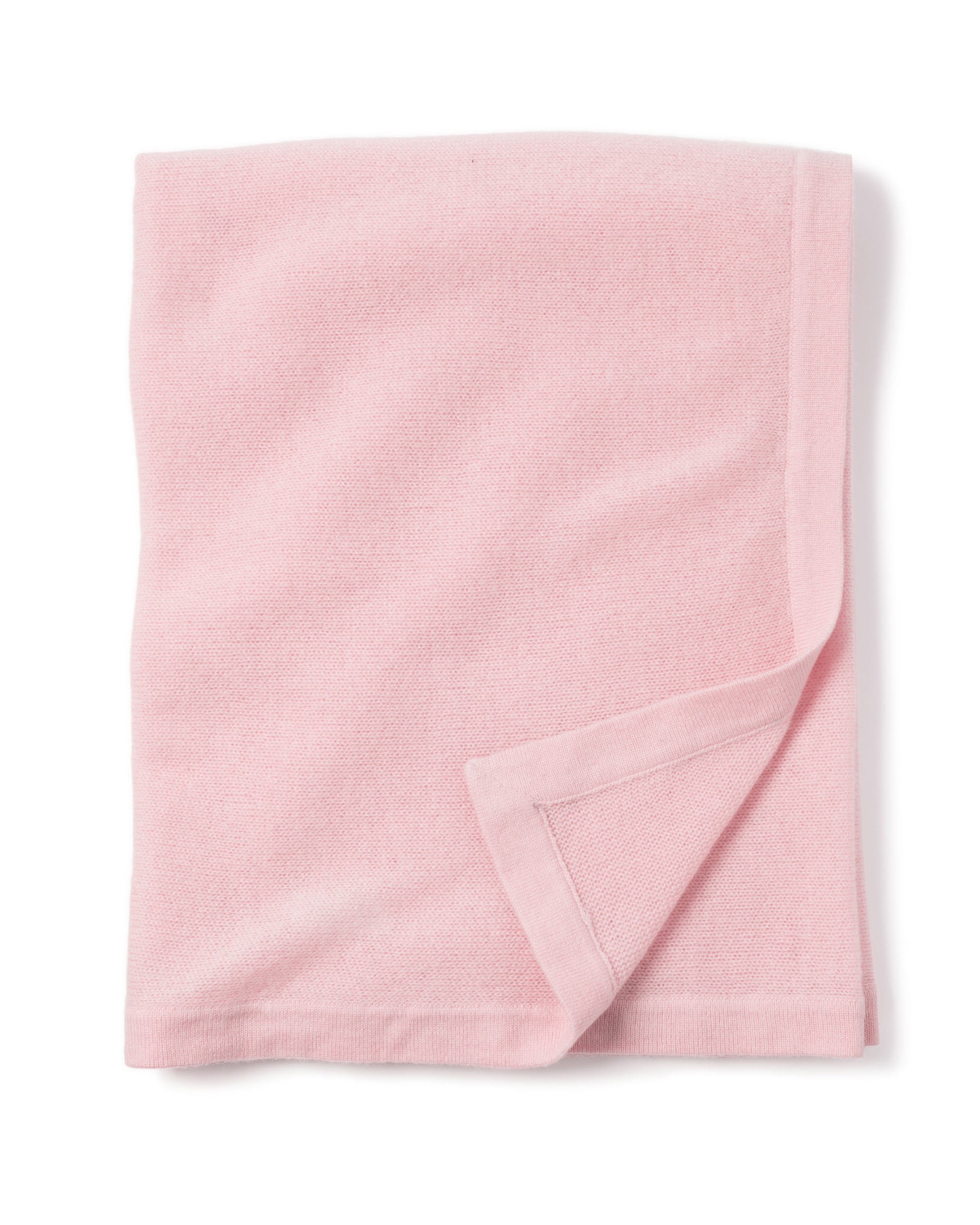 A soft, cashmere baby blanket in rose from Petite Plume is neatly folded against a white background, featuring a simple border detail. Handmade in Nepal, it makes the perfect luxury baby gift.