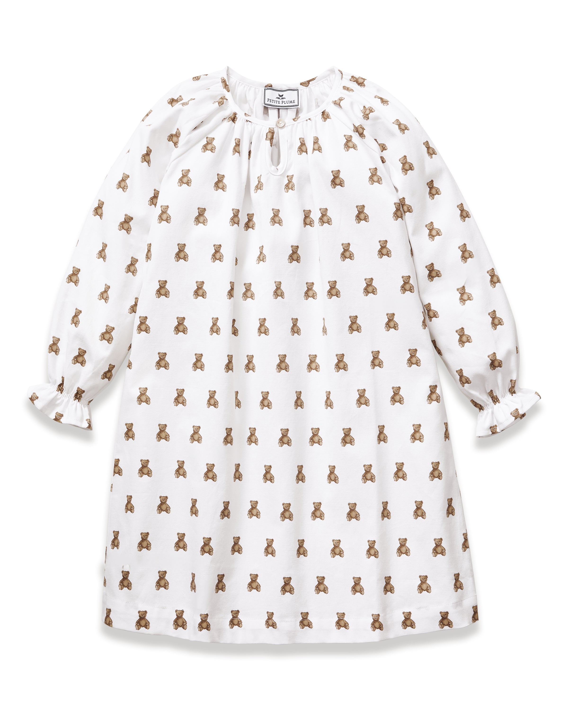 The Girl's Twill Delphine Nightgown in Teddy Tales features long sleeves, a white fabric with an all-over brown teddy bear print, a gathered neckline, ruffled cuffs, and a button closure at the collar.
