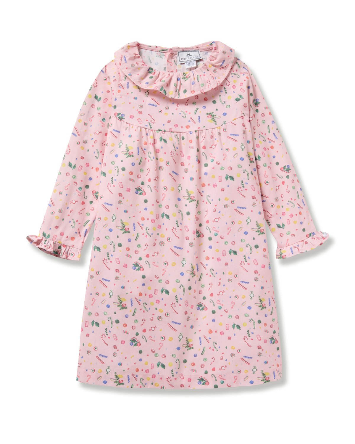The Girls Twill Scarlett Nightgown in Vintage Sweets by Petite Plume is a flame-retardant pink dress with a ruffled collar and cuffs. It boasts a colorful pattern of small shapes in pink, green, yellow, and blue, perfect for playtime adventures or cozy bedtime moments.