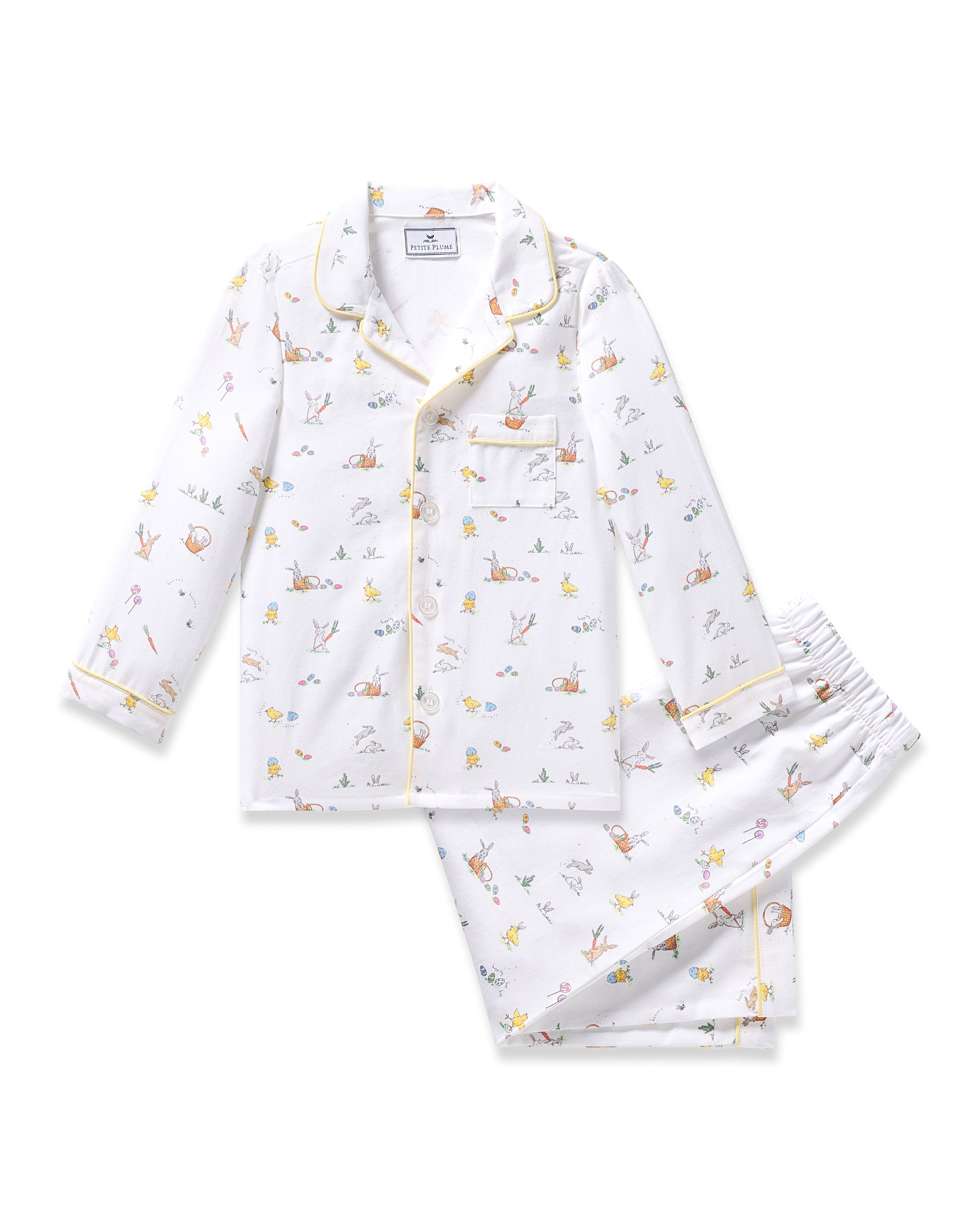 Petite Plumes Kids Twill Pajama in Easter Frolic, a classic white set with button-up top and chest pocket, features playful prints of bunnies, foxes, and trees on both top and matching pants.