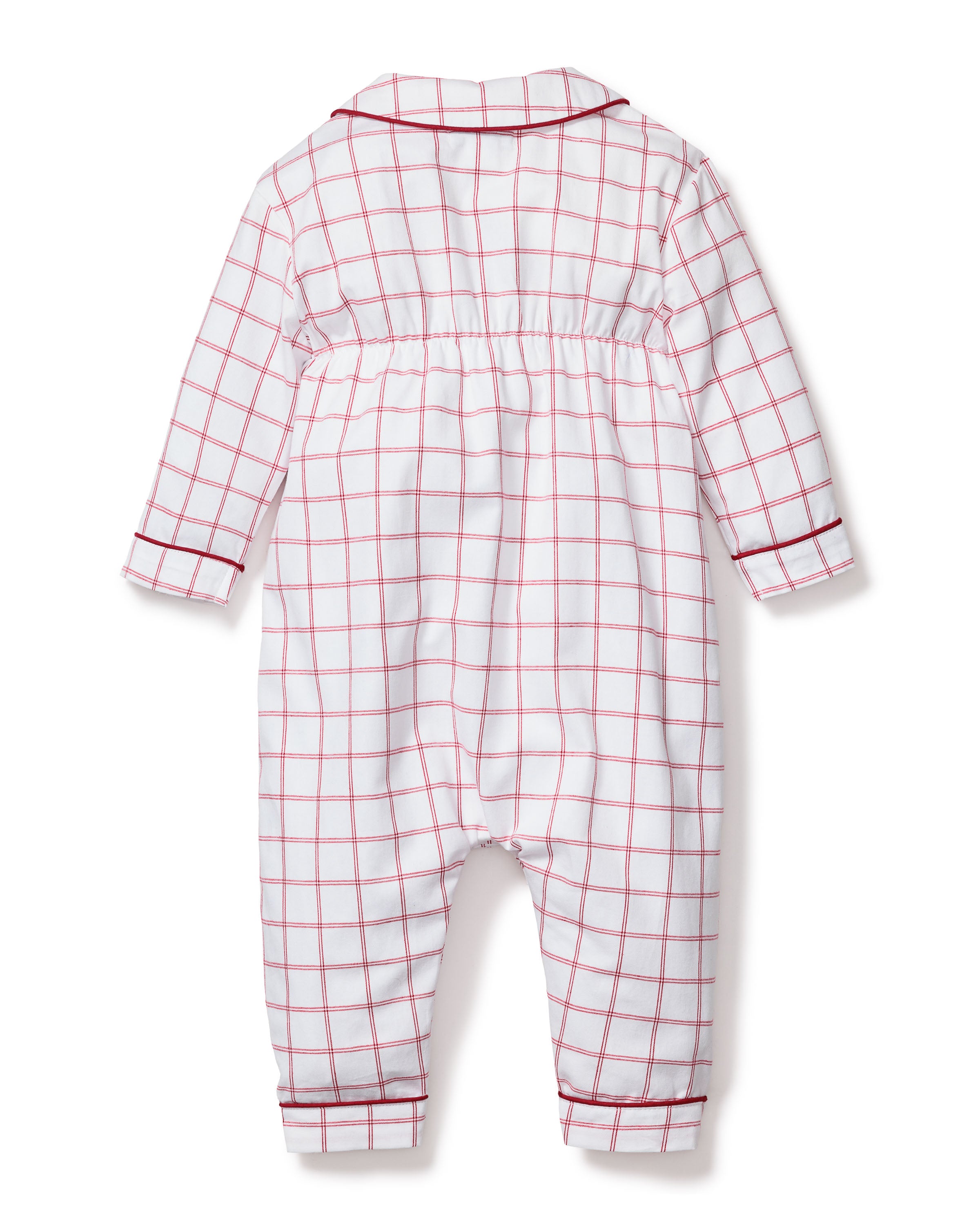 The Petite Plume Babys Twill Cambridge Romper in Garnet Tattersall is a long-sleeve baby onesie featuring a garnet-red and white plaid design. It has red piping on the collar, wrists, and ankles, is made from soft fabric, and includes elastic around the waist for comfortable sleepwear.
