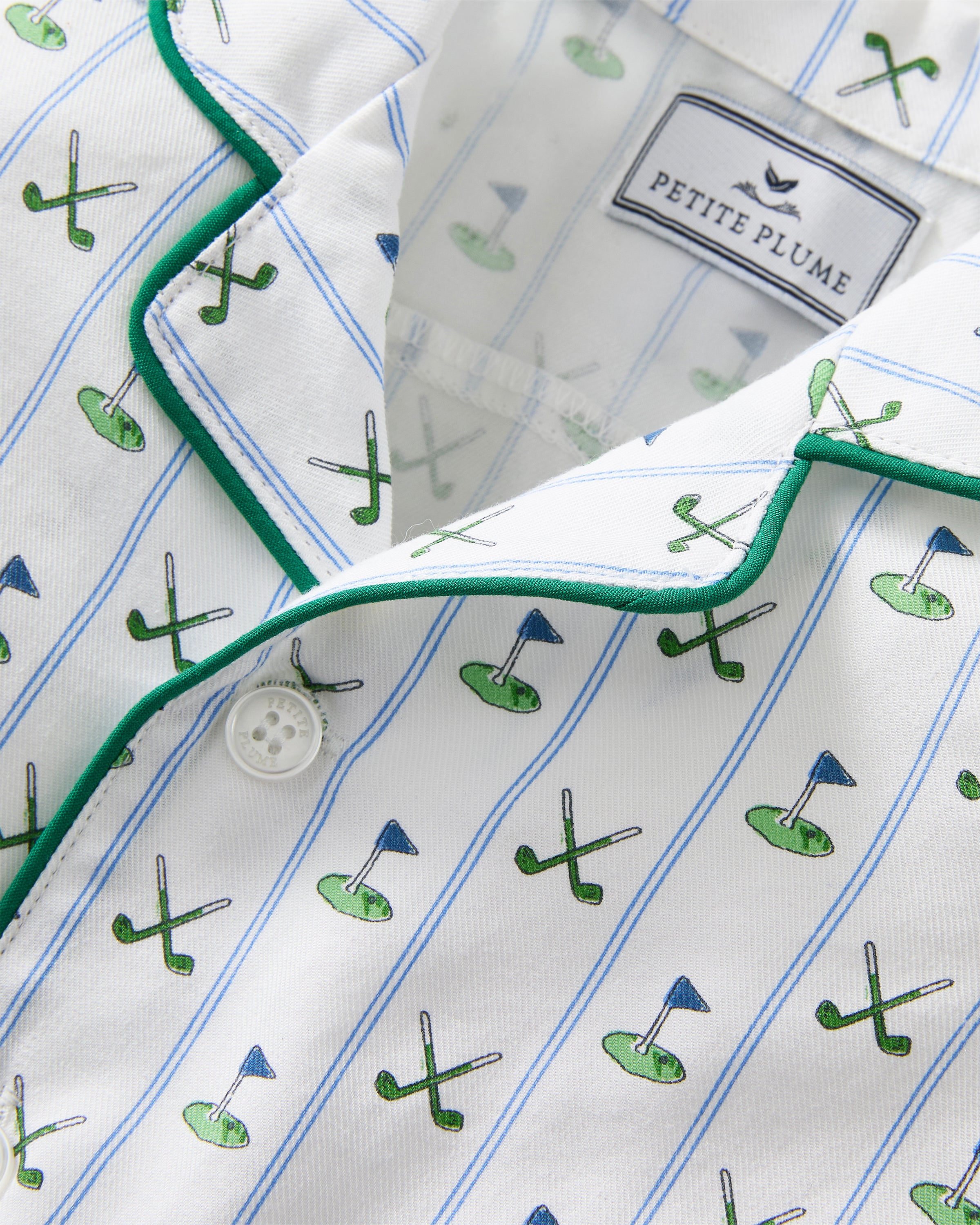 The Baby's Twill Summer Romper in Fairway Stripe is a short-sleeved, button-down romper with green piping, decorated with golf clubs and holes on white fabric with blue vertical stripes.