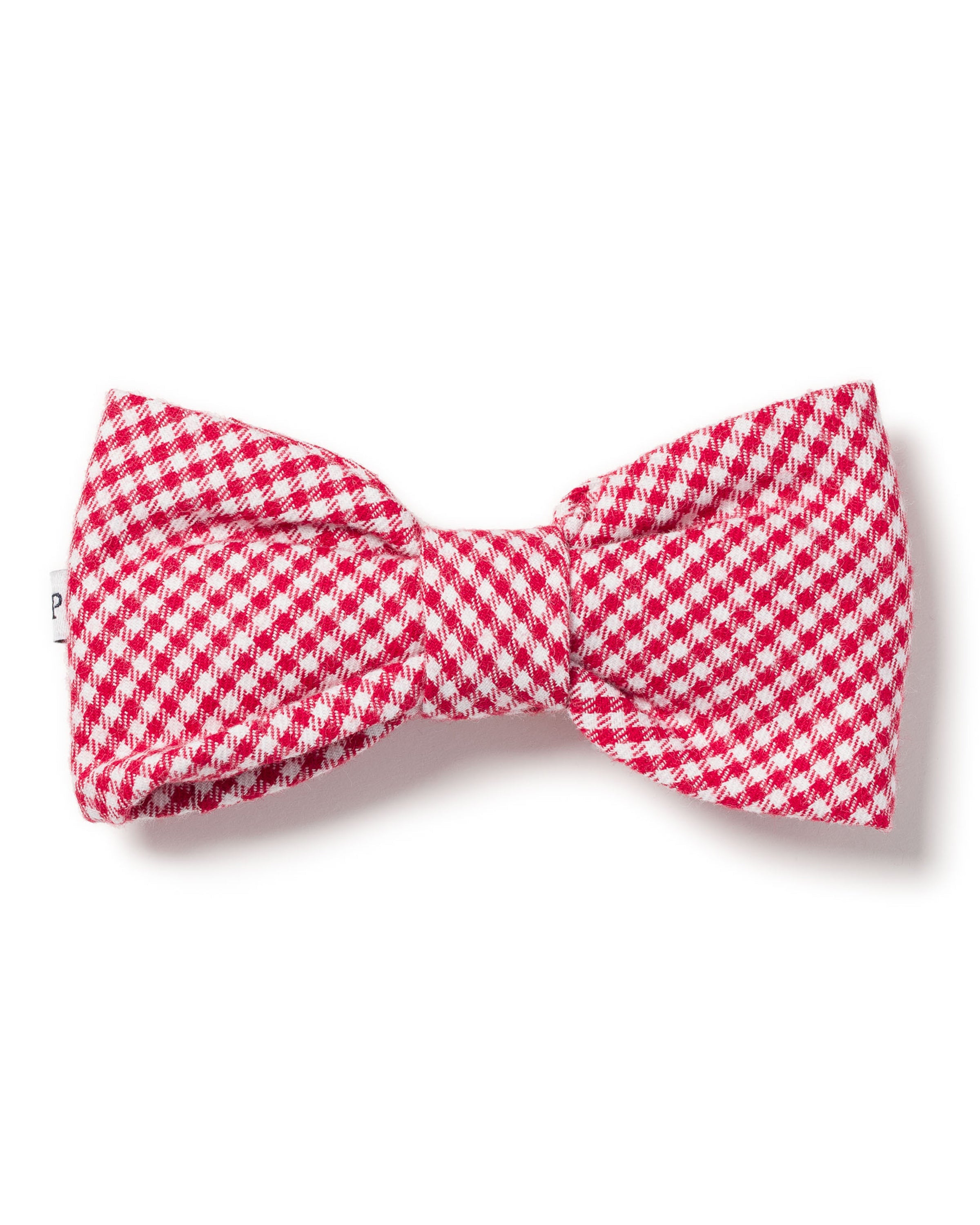 The Red Mini Gingham Dog Bow Tie by Petite Plume adds a charming touch to your festive dog accessories collection, displayed on a crisp white background.