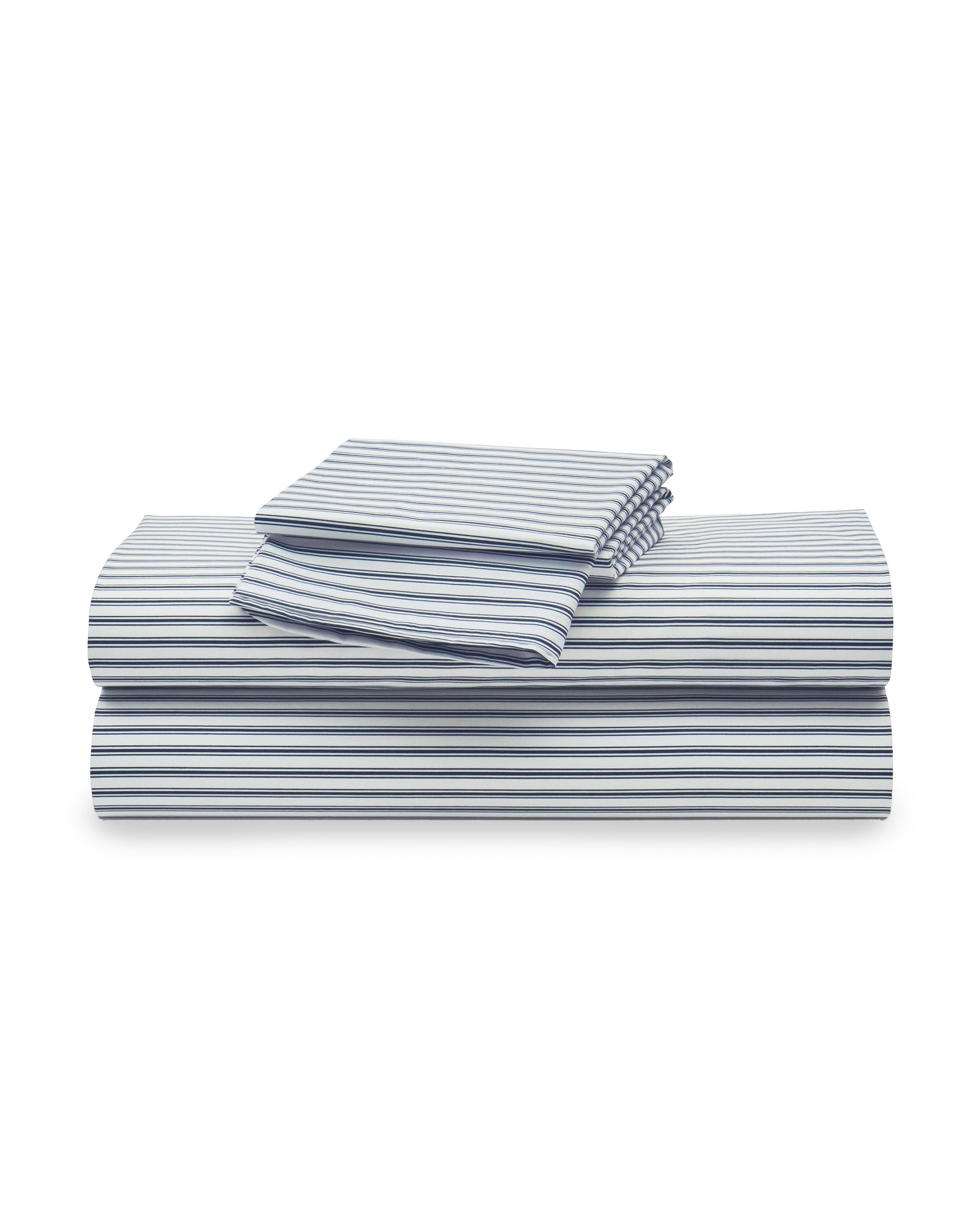 A stack of neatly folded Luxe Premium Cotton Bed Sheets in Navy French Ticking by Petite Plume is seen. Crafted from 100% cotton percale, the set includes a flat sheet, fitted sheet, and two pillowcases.
