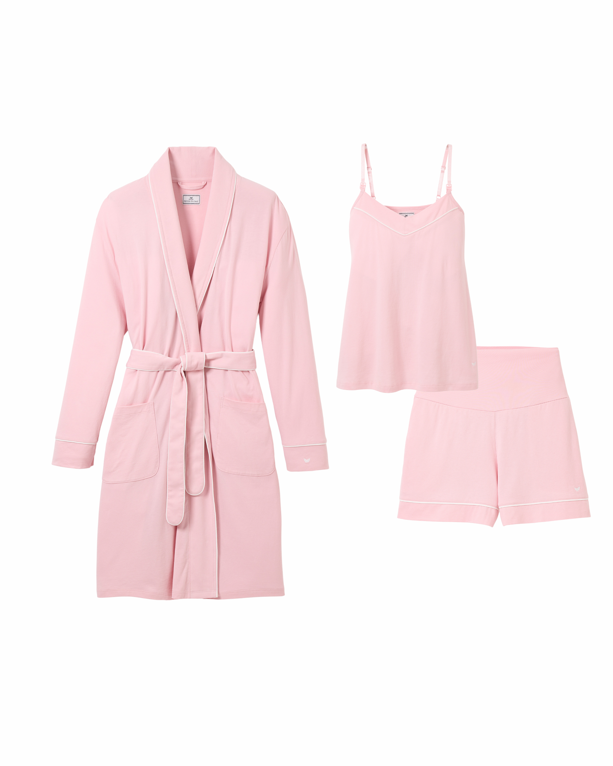 The Must Have Maternity Set in Pink by Petite Plume includes a robe with long sleeves, belt, and pockets, a camisole with thin straps, and relaxed-fit shorts with white trim. Made from lightweight fabric, it’s ideal for gifting or self-indulgence.