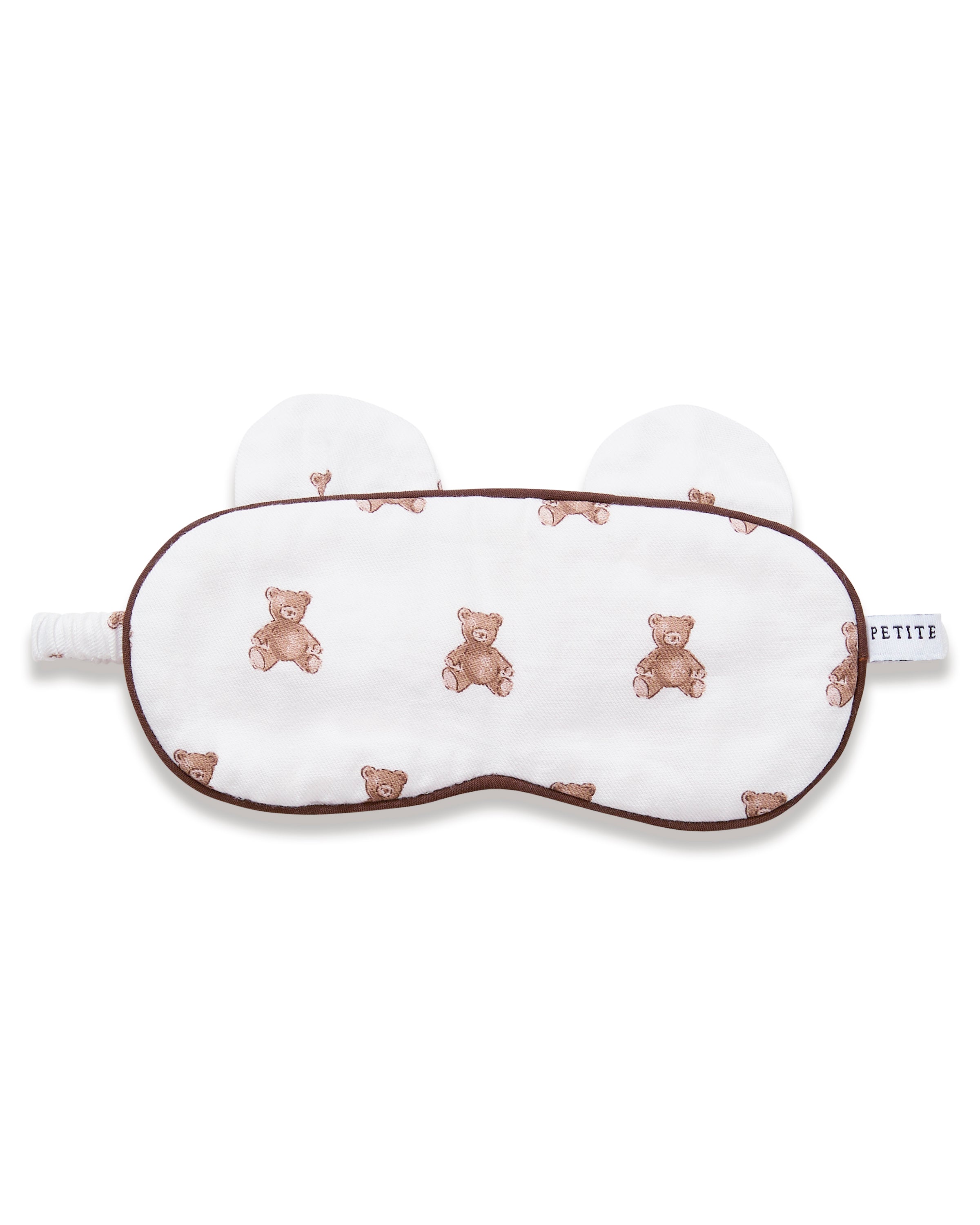 The Kid's Twill Sleep Mask in Teddy Tales features a white design with small brown teddy bear prints, two ear-shaped accents at the top, and a PETITE tag on the right side.