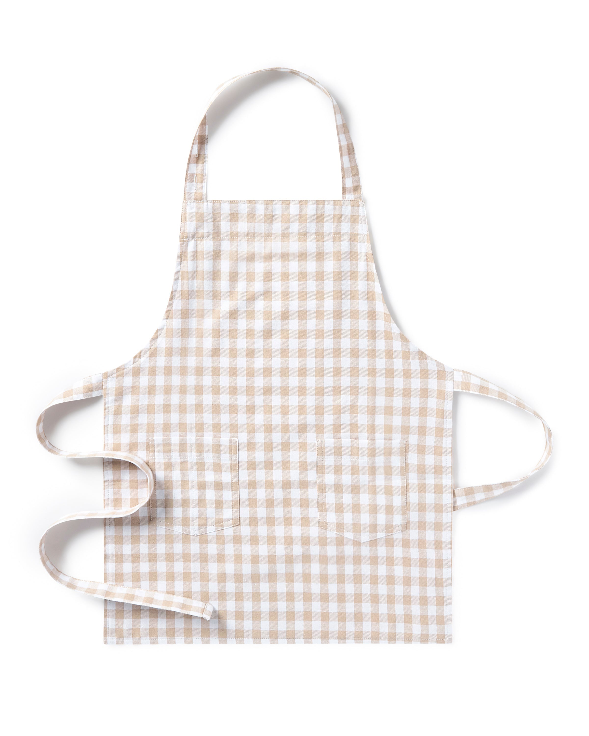 The Kid's Twill Apron in Camel Gingham, featuring a beige and white gingham pattern, two front pockets, and long waist ties, is displayed on a white background.