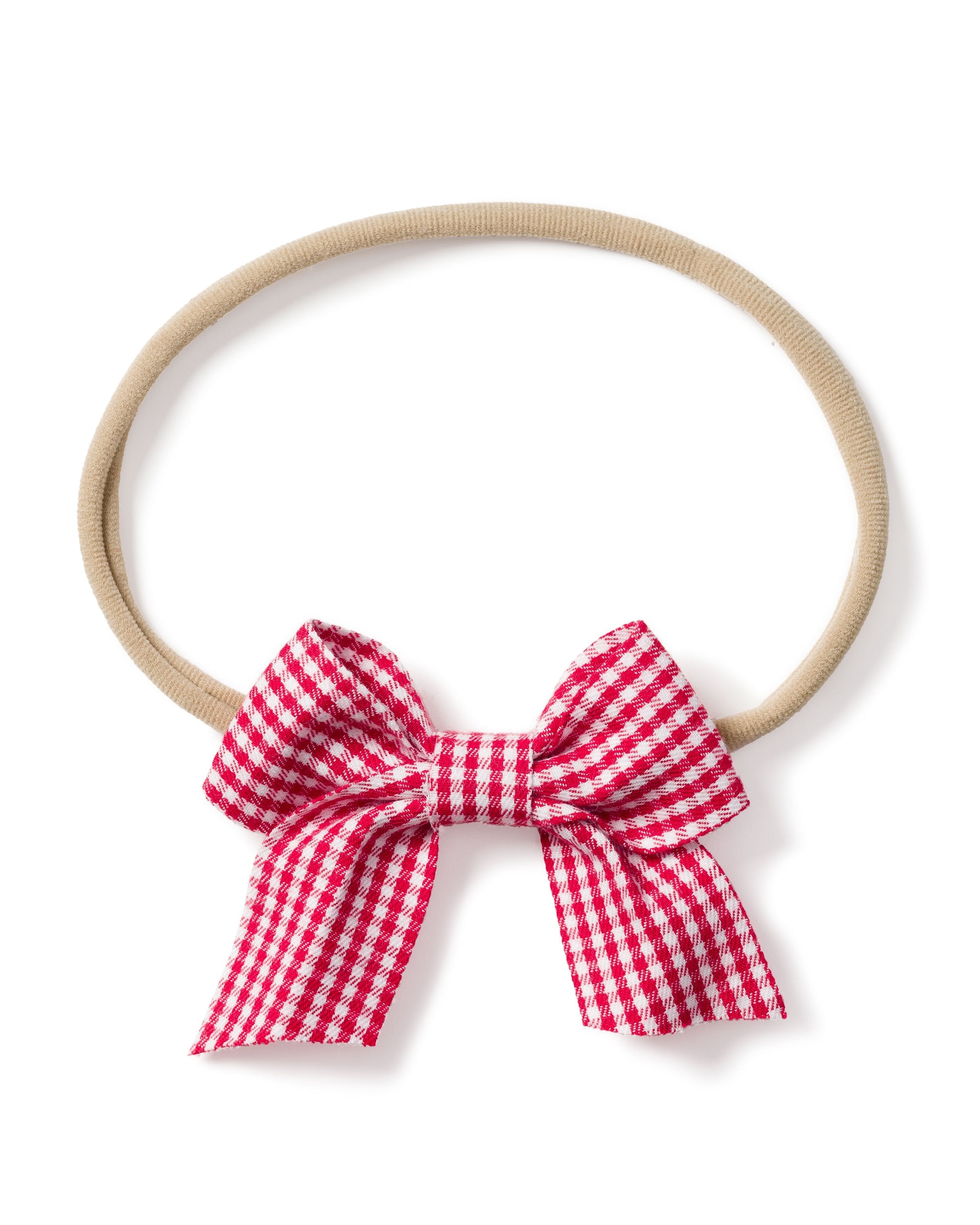 The Petite Plume Girls Hair Bow in Red Mini Gingham is a beige elastic headband with a delightful red and white checkered bow at the bottom, perfect for pajamas and an adorable choice for girls.