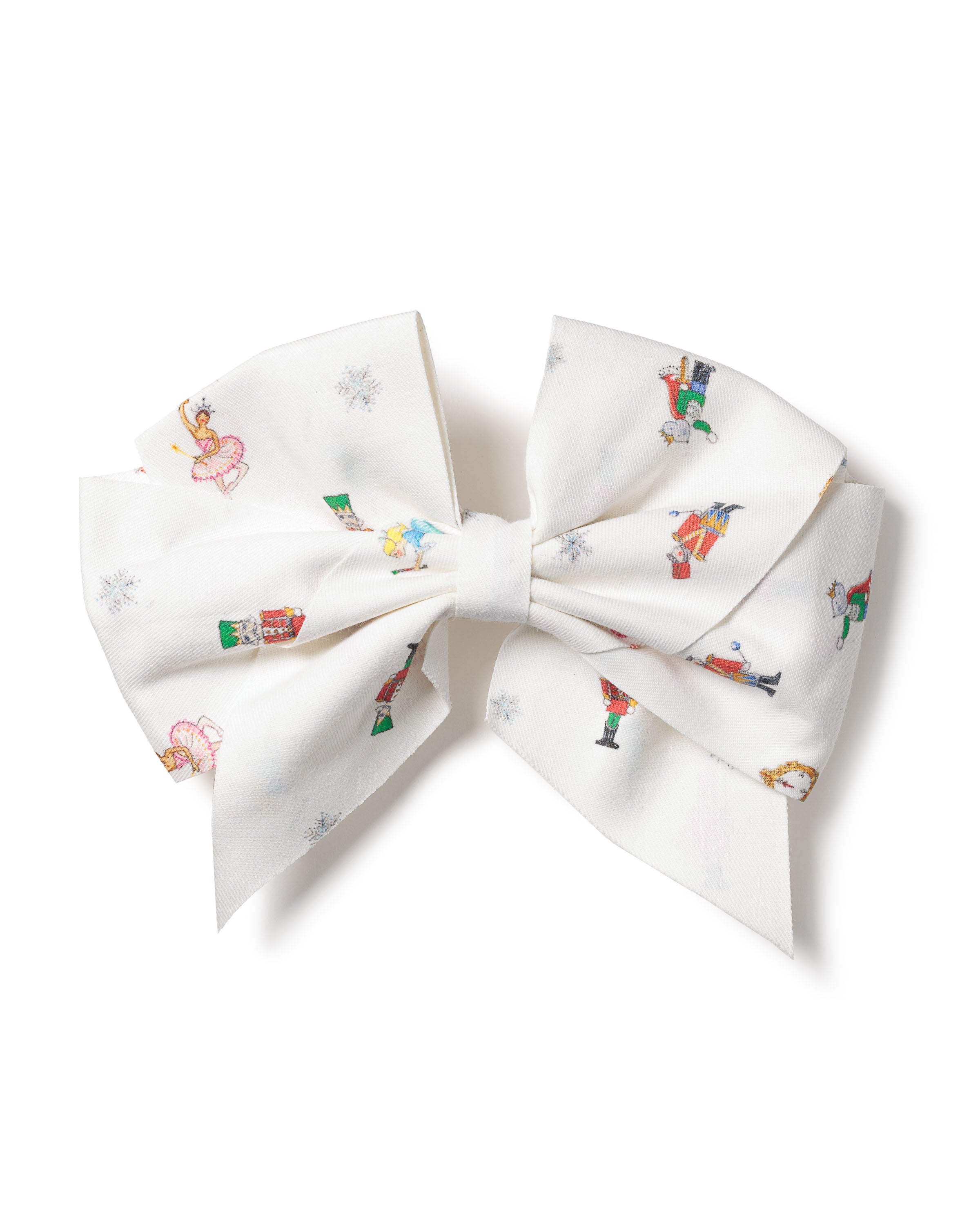 A large white hair bow, Girls Twill Hair Bows in A Night at the Nutcracker by Petite Plume, features colorful Christmas illustrations of snowmen, nutcrackers, dancers, and the Sugar Plum Fairy with snowflakes. It perfectly complements a festive twill romper.