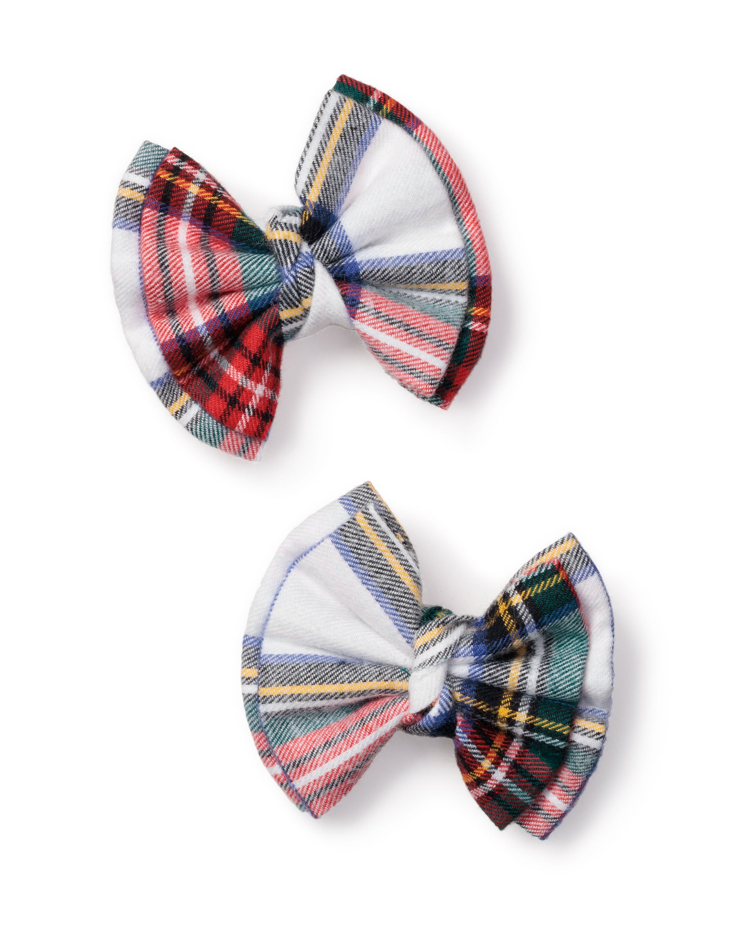 Petite Plume’s Girls Hair Bows in Balmoral Tartan feature two fabric bows in red, green, blue, and white plaid designs. Ideal for festive gifts or girls hair accessories, each bow showcases a distinct pattern on a crisp white background.