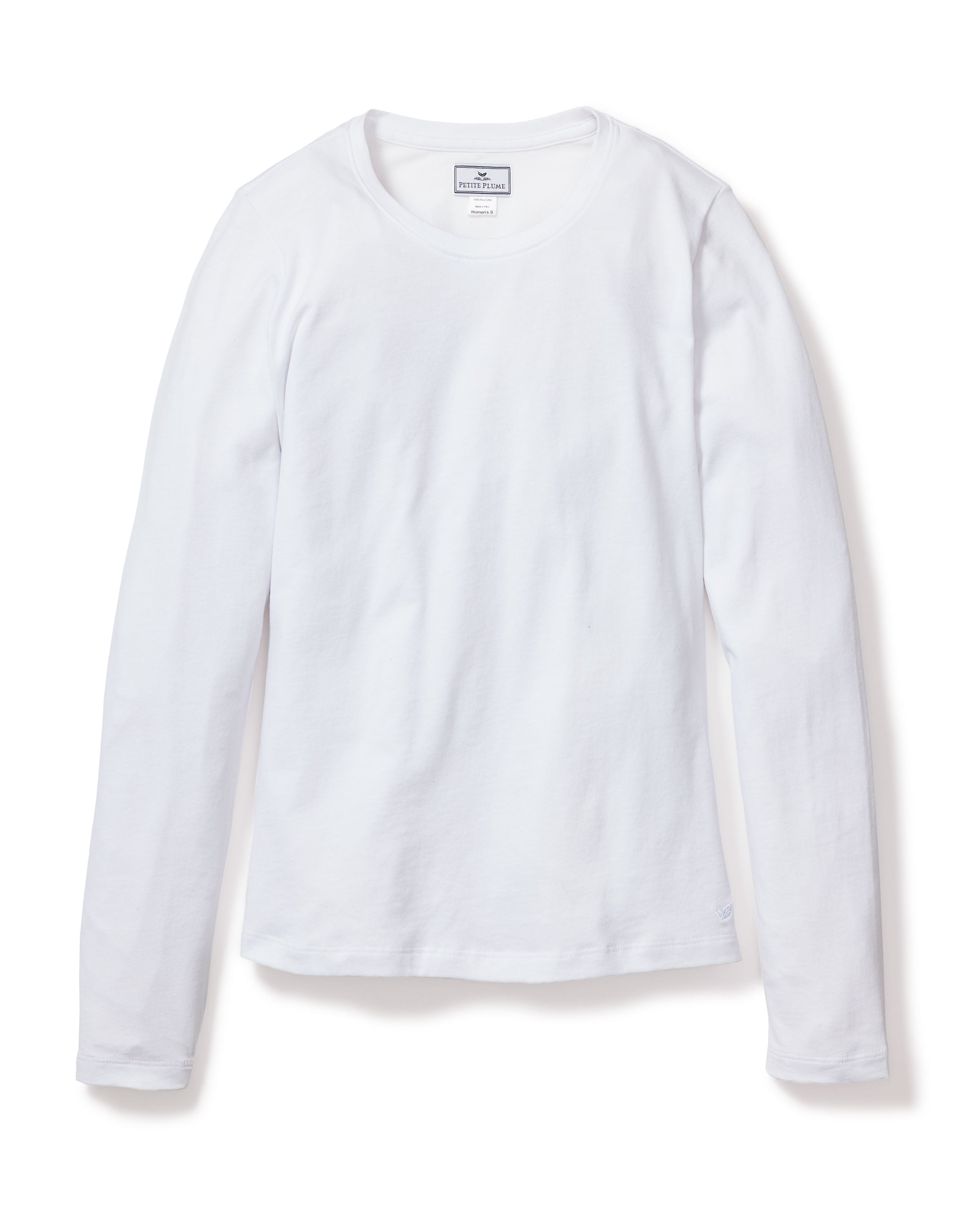 The Womens Pima Long Sleeve Top in White by Petite Plume features a round neckline and is crafted from soft Peruvian Pima cotton, offering a luxurious feel akin to high-end pajamas. A small label at the neckline is also visible. .