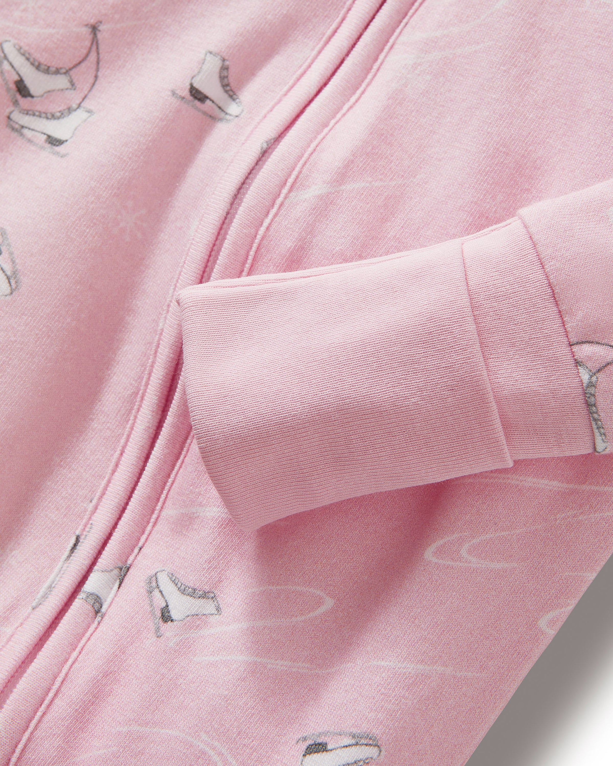 The Baby's Pima Peekaboo Romper in Winter Skates is a pink long-sleeve, long-leg romper with a subtle white bird print, diagonal neck-to-leg zipper, and ribbed cuffs at wrists and ankles.