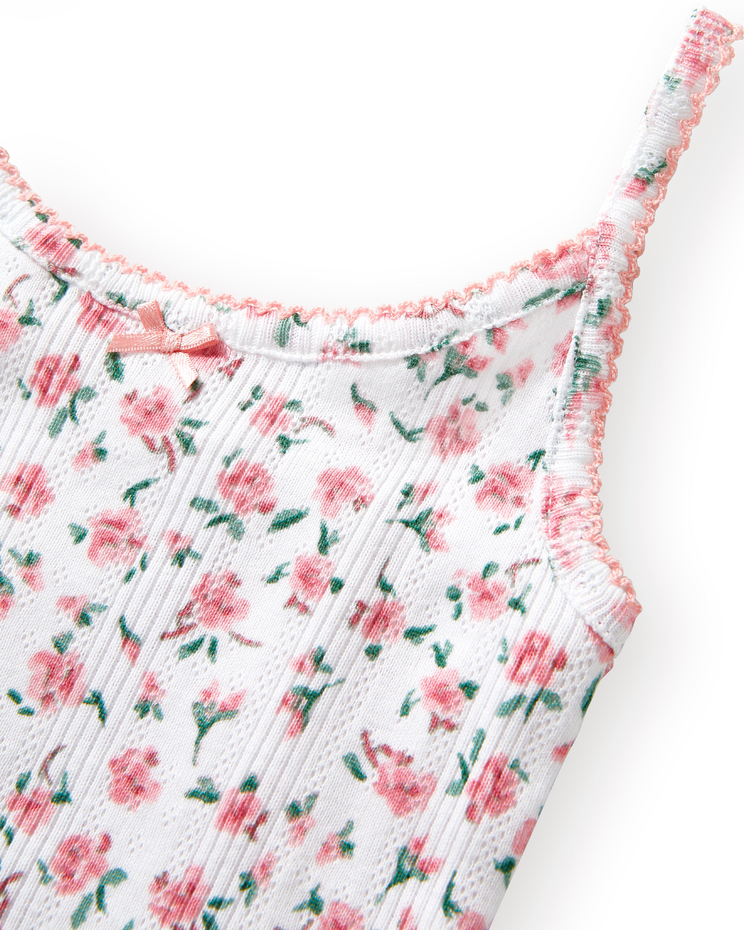 The Kid's Pointelle Cami Set of 2 in White & Pink Floral includes two sleeveless camisoles: one plain white with a bow and one white with a pink and green floral pattern. Both feature thin straps and lace trim.