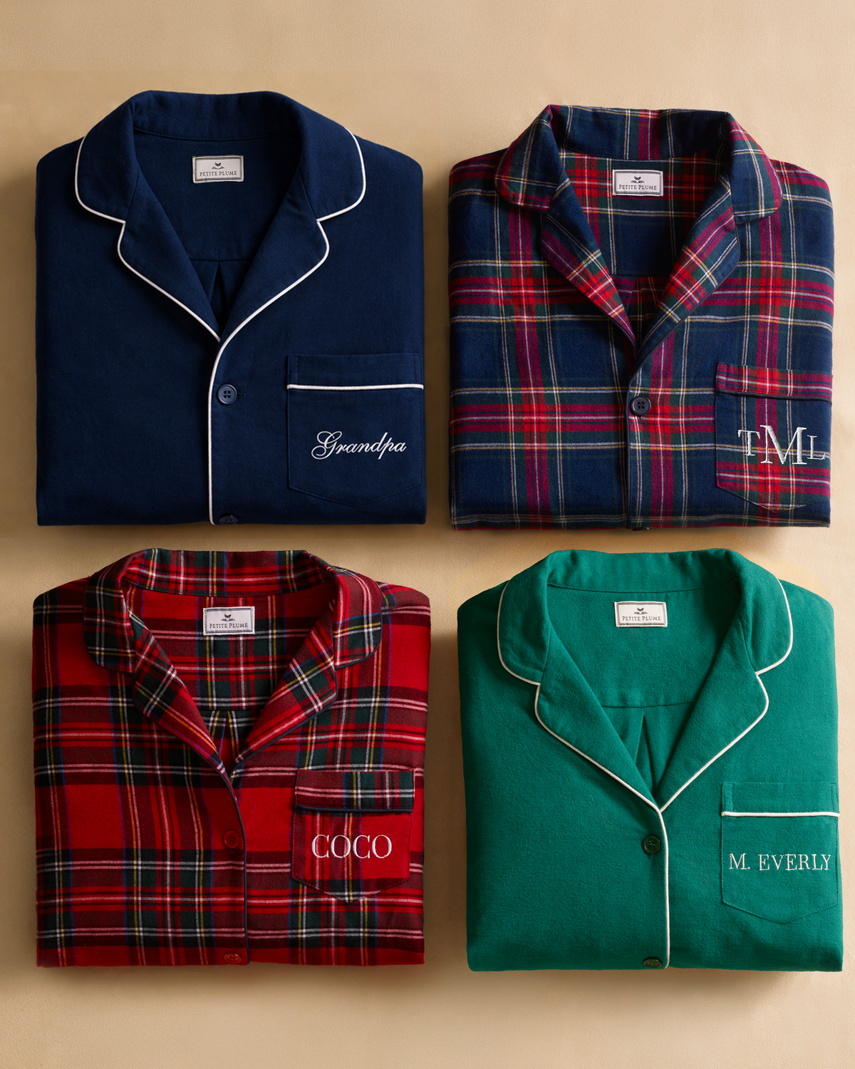 Four folded Men’s Brushed Twill Pajama Set in Windsor Tartan shirts in solid navy, green, and two red plaid patterns, each featuring a white chest pocket embroidered with different names or initials.