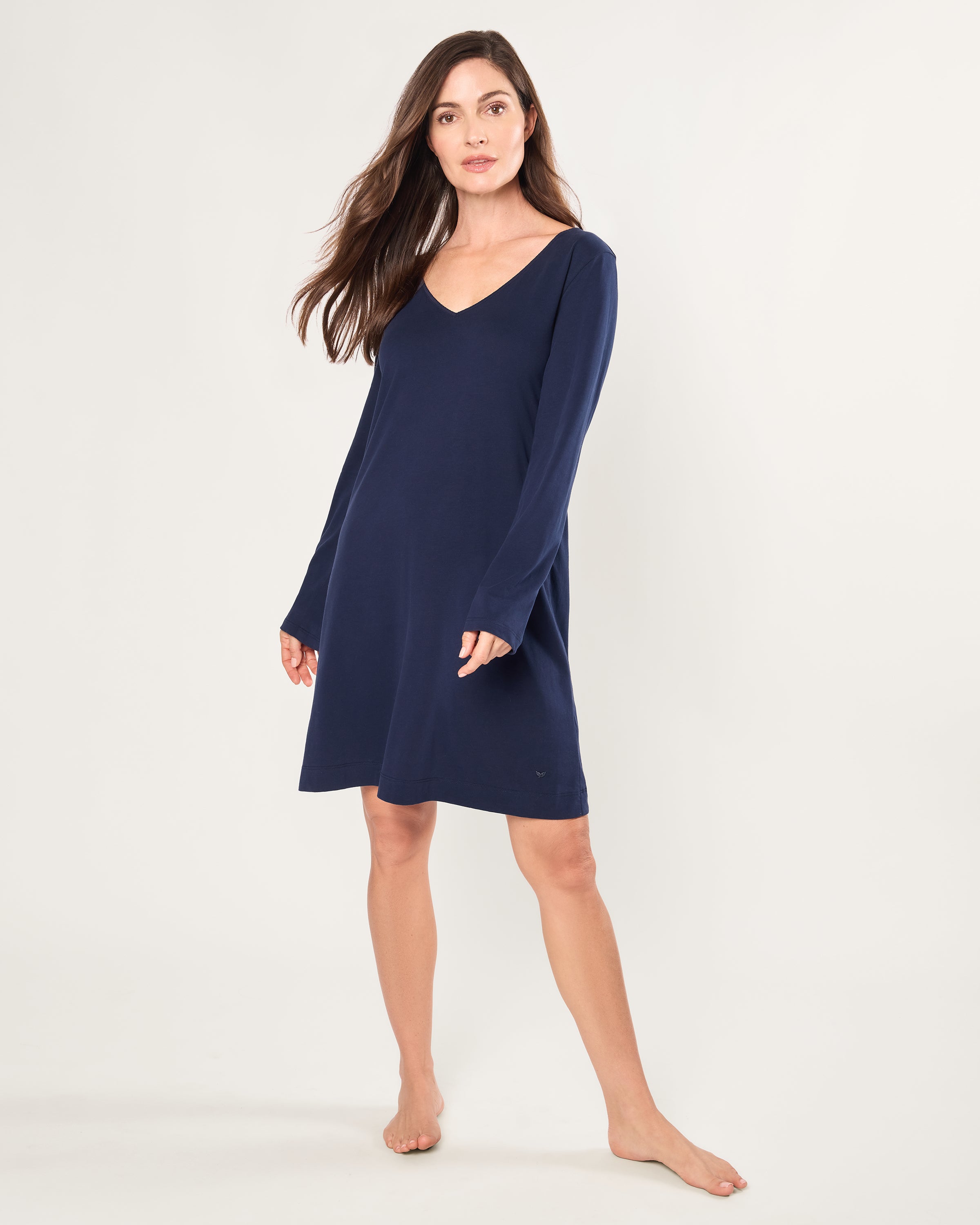 Woman wearing a navy blue dress on a white background