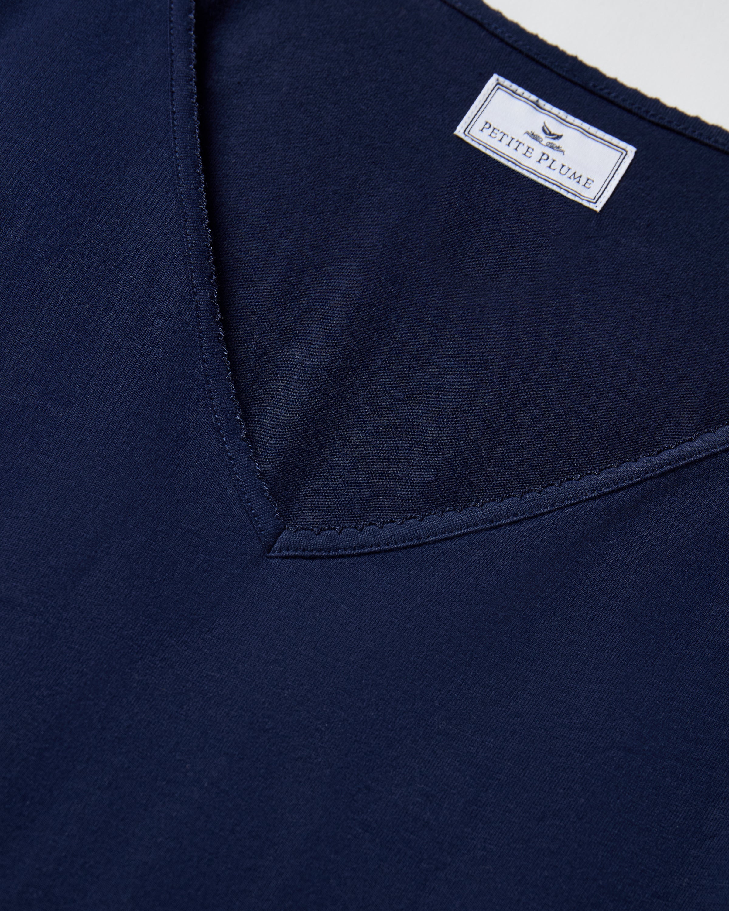 The Women's Pima Long Sleeve Harper Nightgown in Navy is shown laid flat on a white background, featuring a V-neckline and knee-length design.