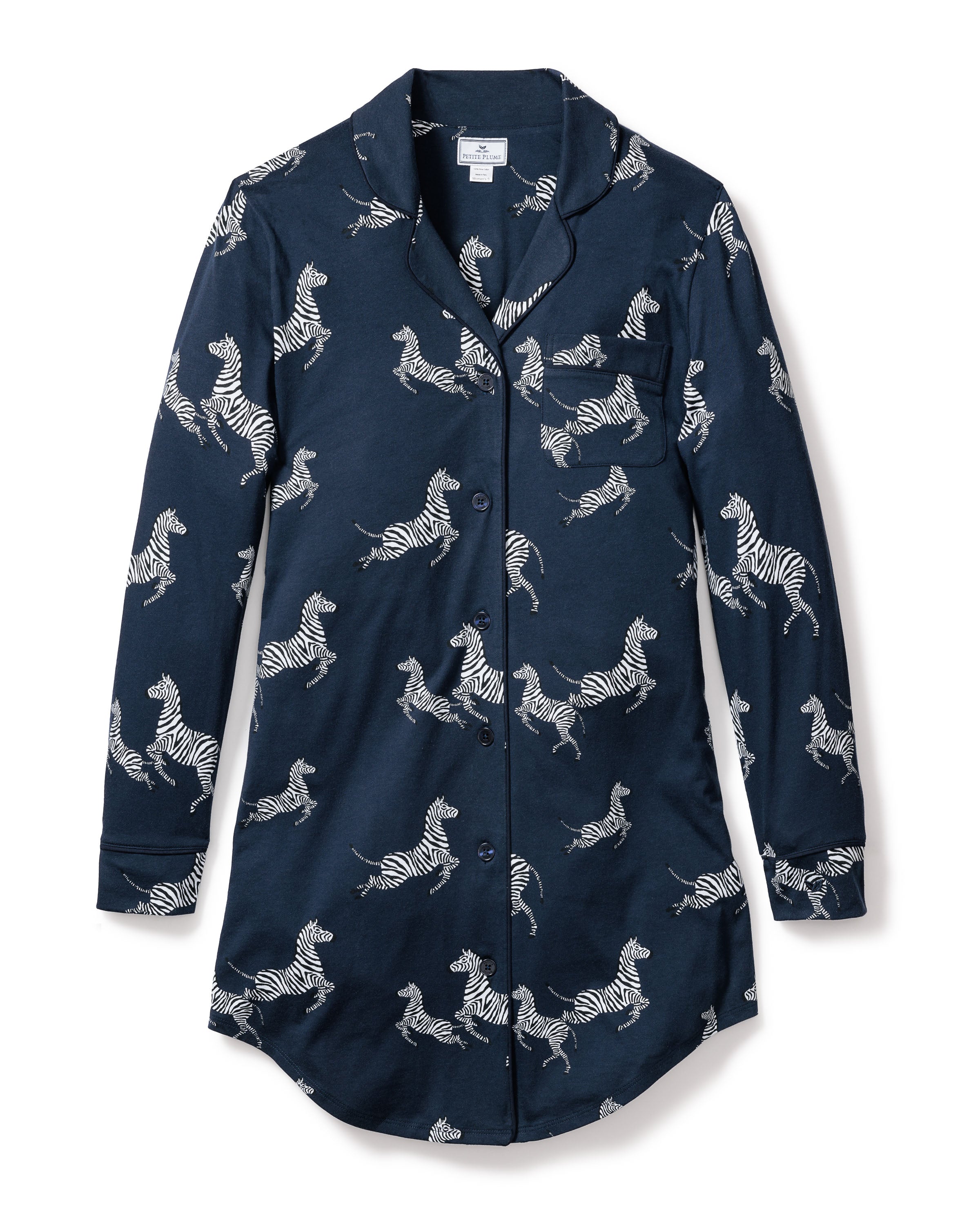 Experience luxury with the Womens Pima Nightshirt in Zèbre de Nuit, a navy long-sleeve, button-up crafted from Peruvian Pima cotton. It boasts an all-over zebra print, a handy chest pocket, and a chic curved hem.