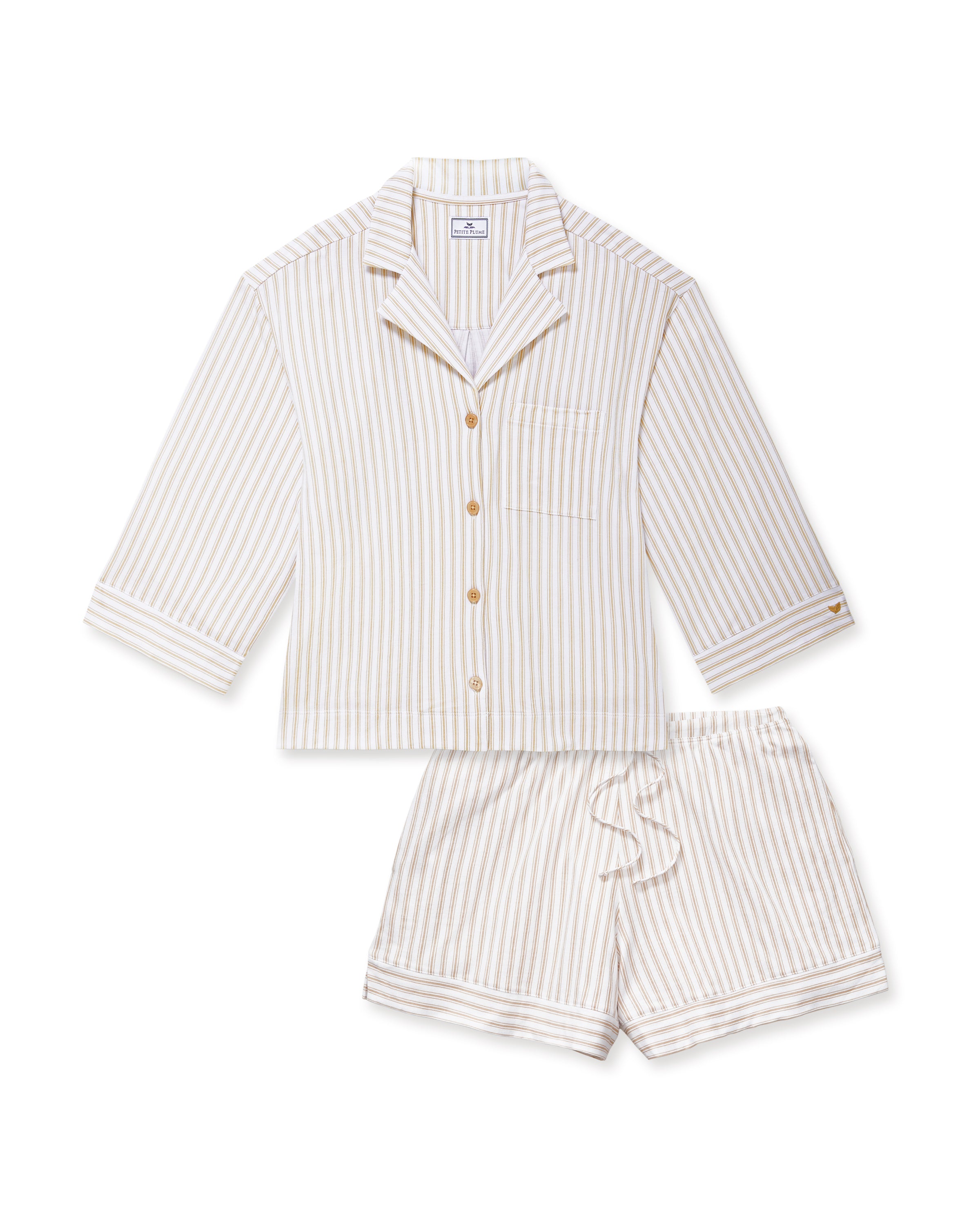 The Olivia Pima Short Set in Camel Ticking features a two-piece pajama set with beige and white vertical stripes, including a button-up, collared long-sleeve shirt with a breast pocket, and matching relaxed-fit drawstring shorts.