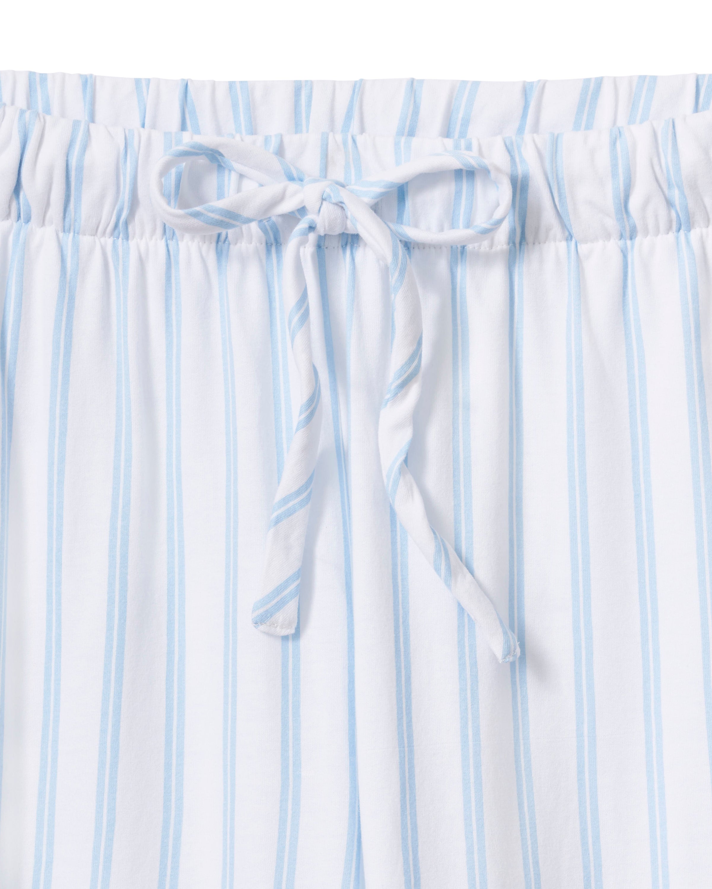 The Olivia Pima Short Set in Periwinkle Stripe features light blue and white vertical stripes, a short-sleeve button-up shirt with a chest pocket, and matching drawstring shorts.