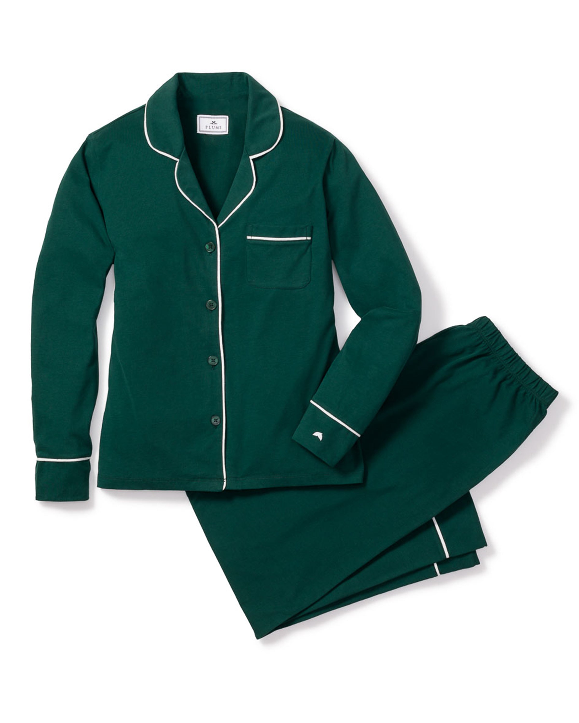 The Women's Pima Pajama Set in Evergreen features a dark green button-up long-sleeve top with white piping, chest pocket, and collar, plus elastic-waist pants, all laid flat on a white background.