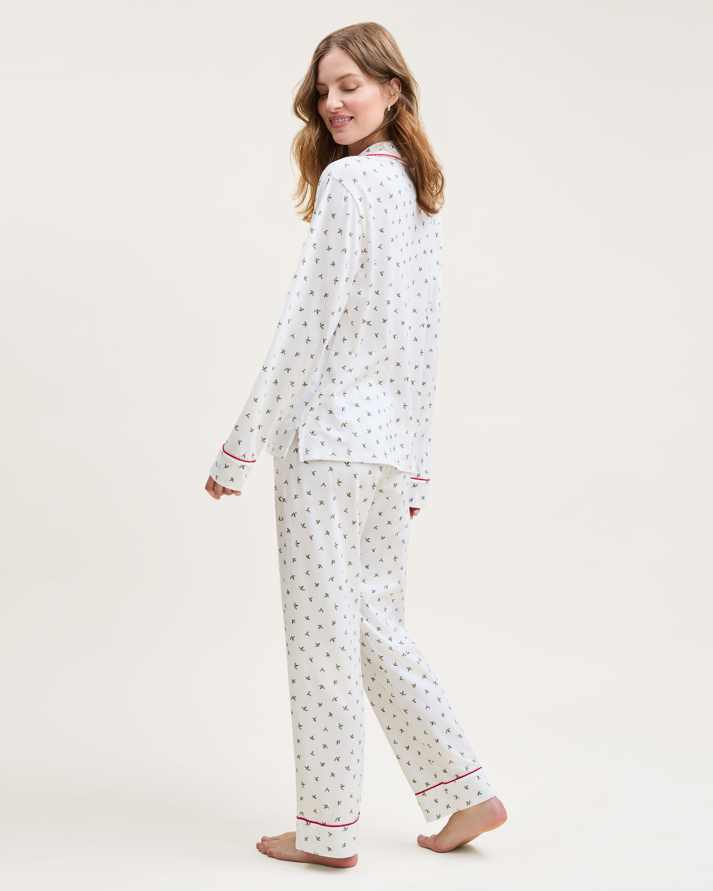 Women's Pima Pajama Set in Mistletoe Moments features small green palm tree prints, red piping, a chest pocket, and matching pants, all displayed flat on a white background.
