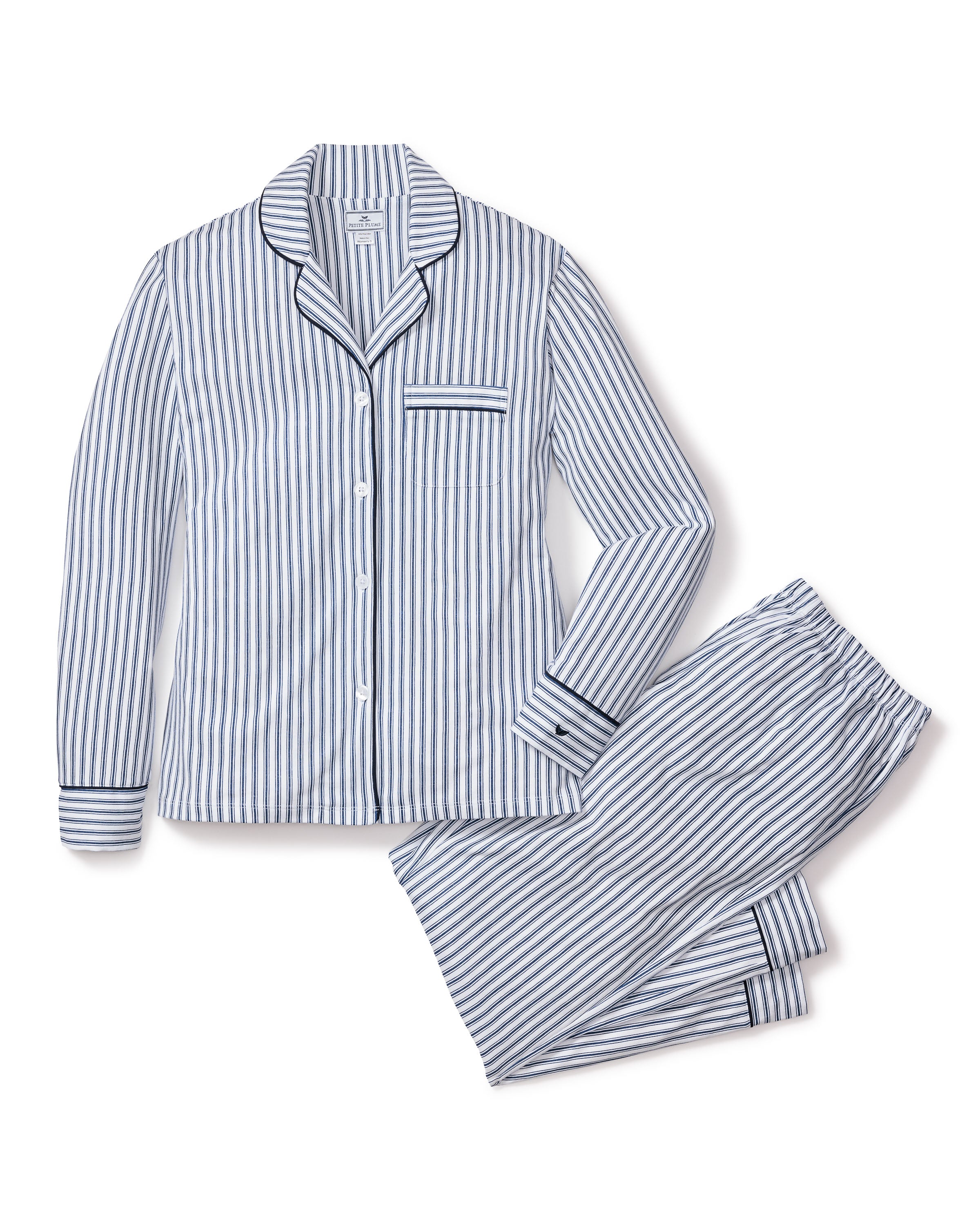 The Women’s Pima Pajama Set in Navy French Ticking features a neatly arranged blue and white vertical stripe design with a button-up long-sleeve top and matching pants.