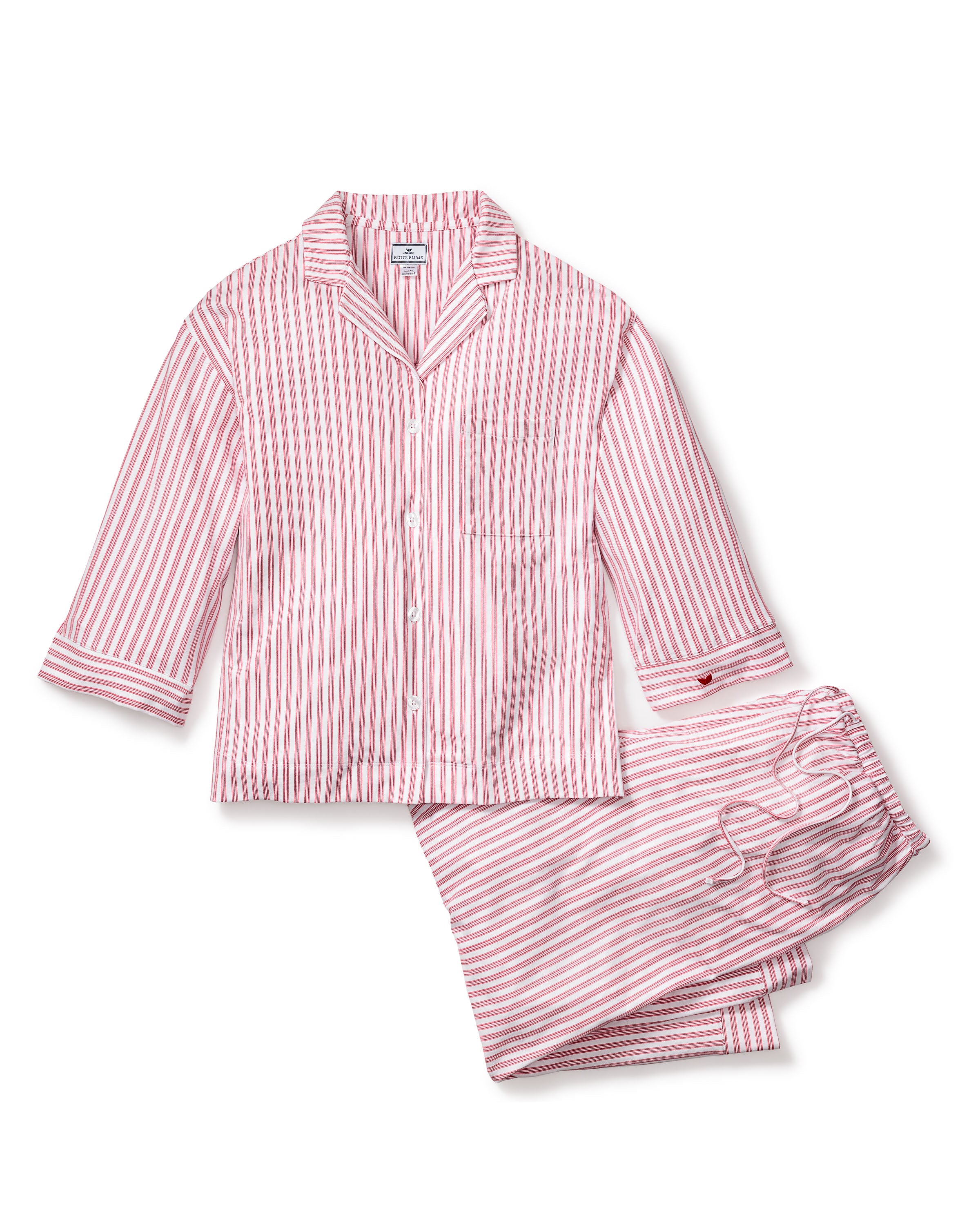 The Olivia Wide Leg Pima Pajama Set in Antique Red Ticking by Petite Plume is a luxurious set featuring soft, pink and white striped Peruvian Pima cotton. The top has long sleeves, a collar, and front buttons, while the loose pants include a drawstring waist for comfort.