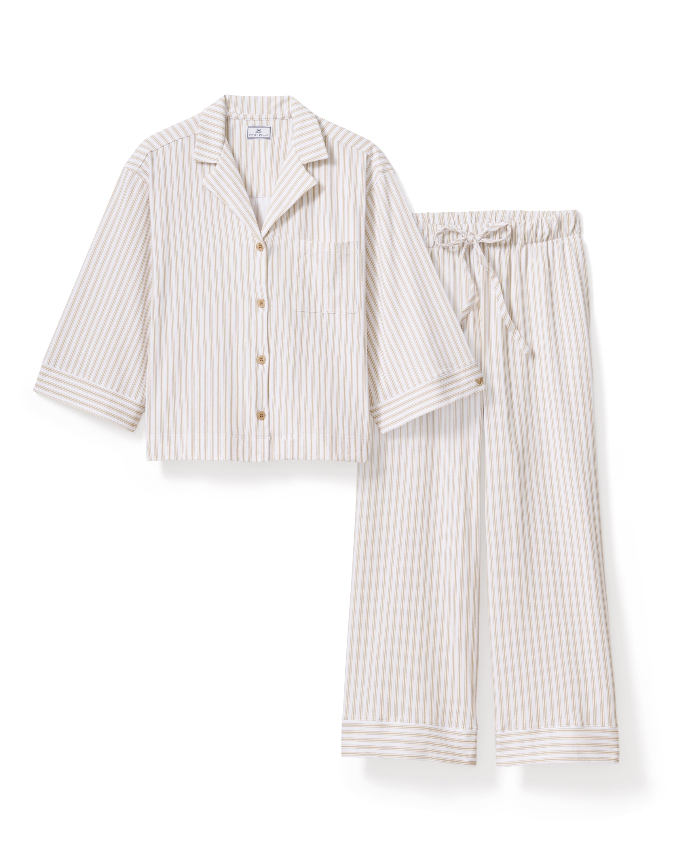 The Olivia Wide Leg Pima Pajama Set in Camel Ticking features light-colored, long-sleeve striped pajamas with brown buttons and matching drawstring pants, displayed flat on a white background.