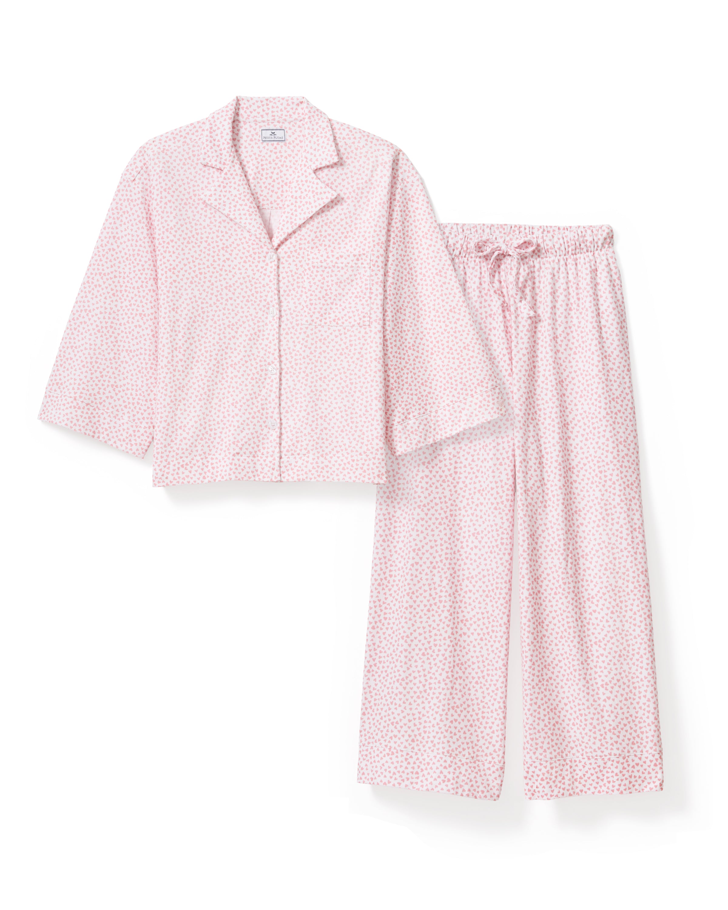 The Olivia Wide Leg Pima Pajama Set in Sweethearts features a light pink and white dotted design, with a collared long-sleeve button-up top and matching wide-leg drawstring pants.