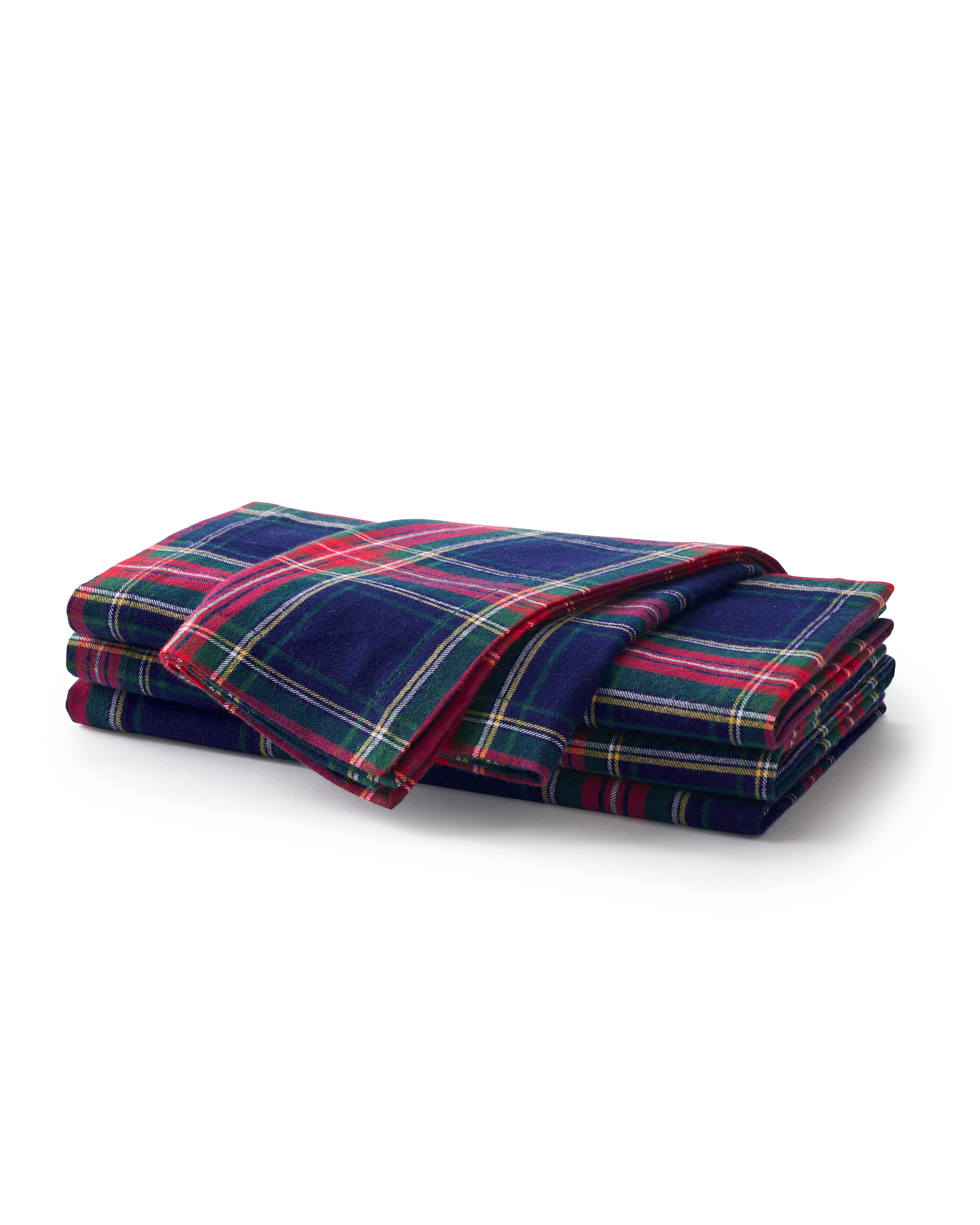 A neatly stacked set of Signature Twill Napkins in Windsor Tartan by Petite Plume, crafted from 100% cotton. They feature blue, red, green, and yellow stripes on a plain white background—perfect for any festive tablescape.