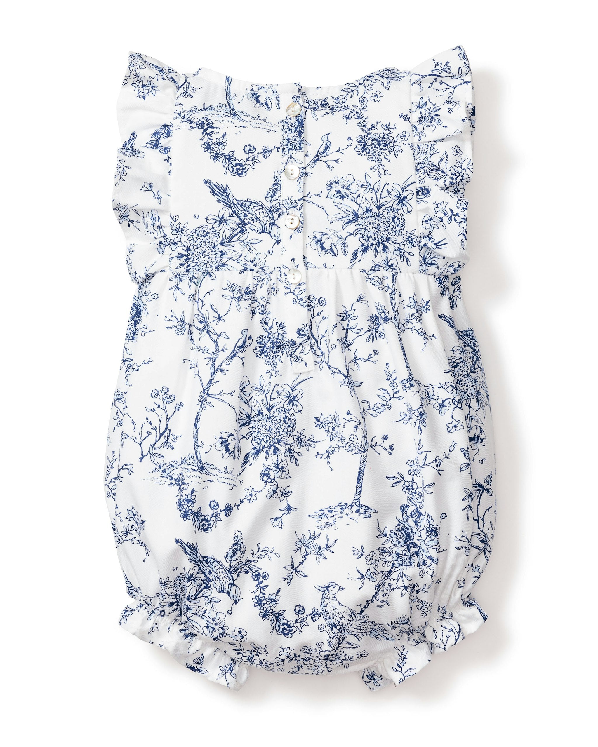 The Babys Twill Ruffled Romper in Timeless Toile by Petite Plume is a white romper with blue floral and botanical prints, ruffled sleeves, a cinched waist, and elastic leg openings for a gathered, airy look.