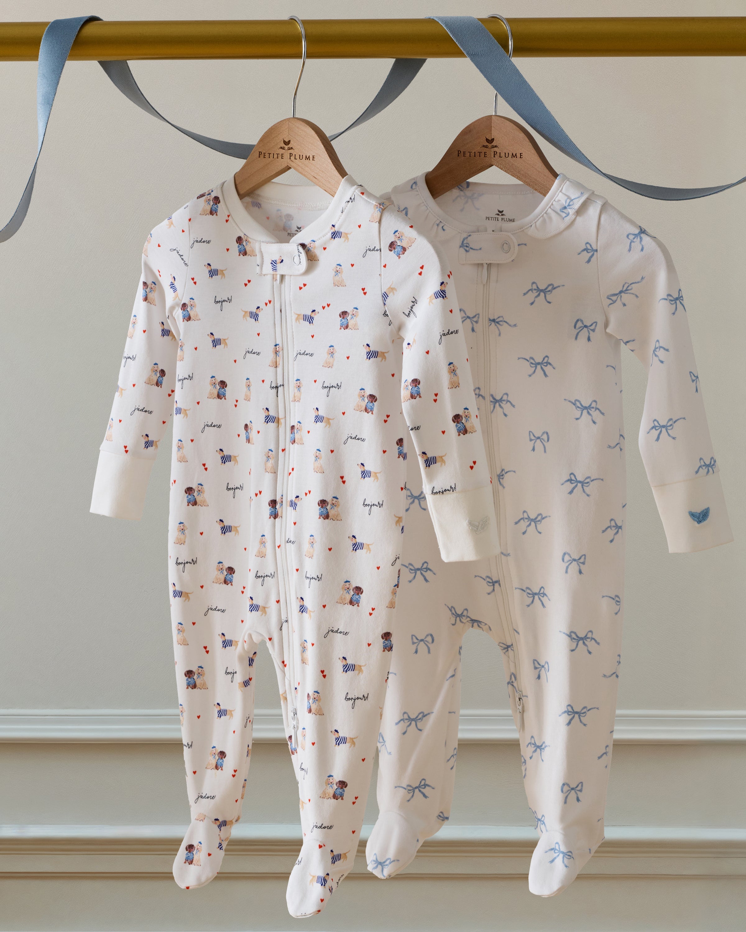 Baby's Pima Ruffle Collar Romper in Something Blue Bows: white long-sleeve onesie with covered feet, zipper front, and a print of small blue bow illustrations.