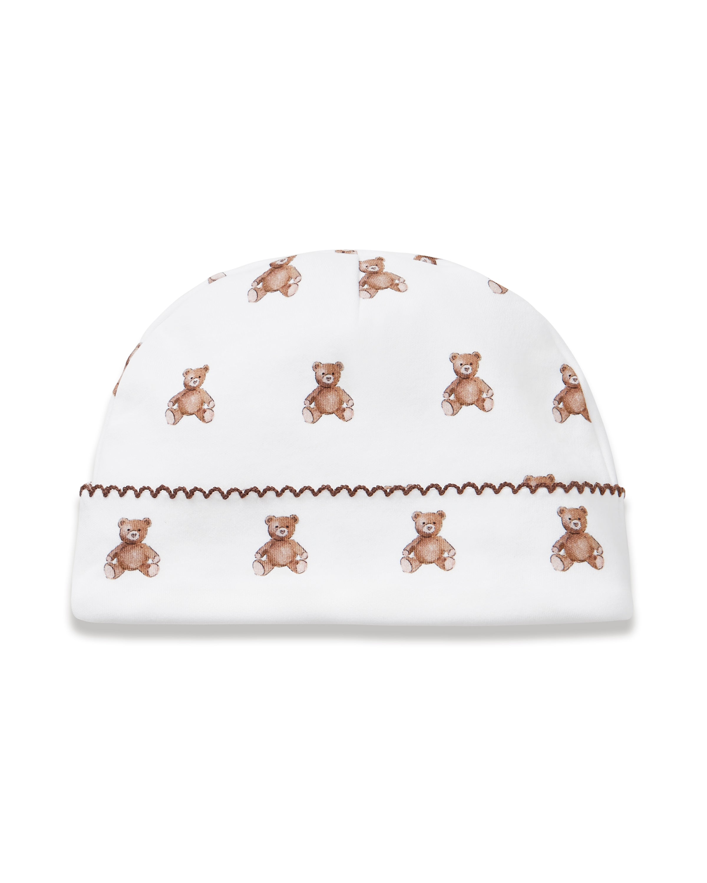 The Baby Pima Hat in Teddy Tales is a white baby hat with a brown teddy bear pattern and a decorative brown zigzag stitch along the brim.