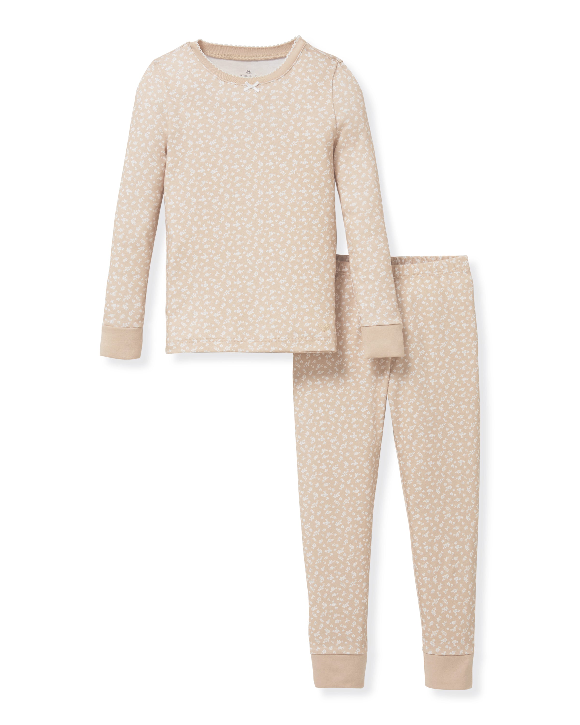 The Kid's Pima Snug Fit Pajama Set in Ditsy Waltz Camel features a beige long-sleeve top and matching pants with a white floral pattern and solid beige cuffs on the sleeves, neckline, and pant legs.