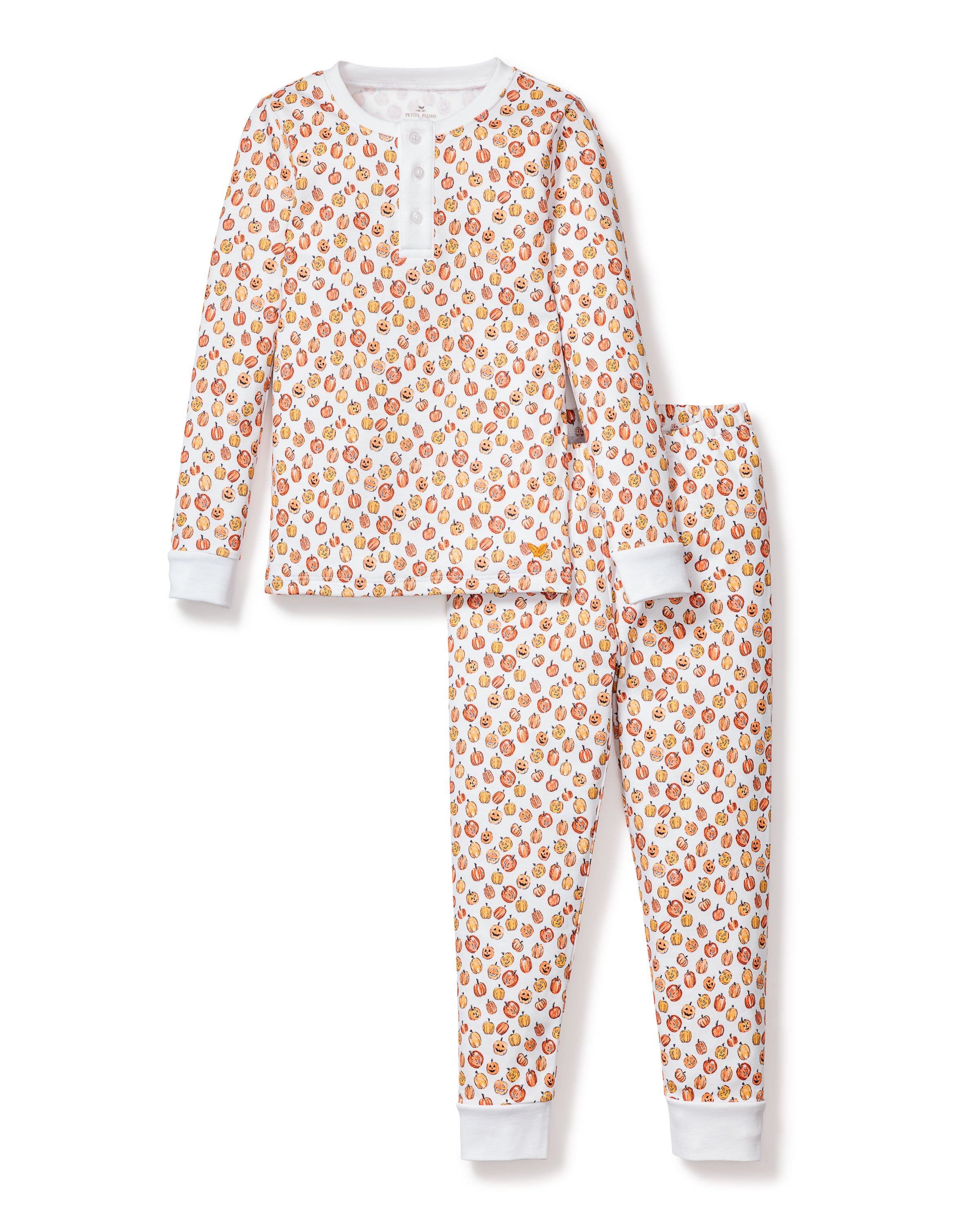 The Kids Pima Snug Fit Pajama Set in Pumpkin Patch by Petite Plume features a soft Pima Cotton long-sleeve top and pants. With a white background adorned with small colorful pumpkins, and solid white cuffs and neckline, this sleepwear set is charming and cozy for children.