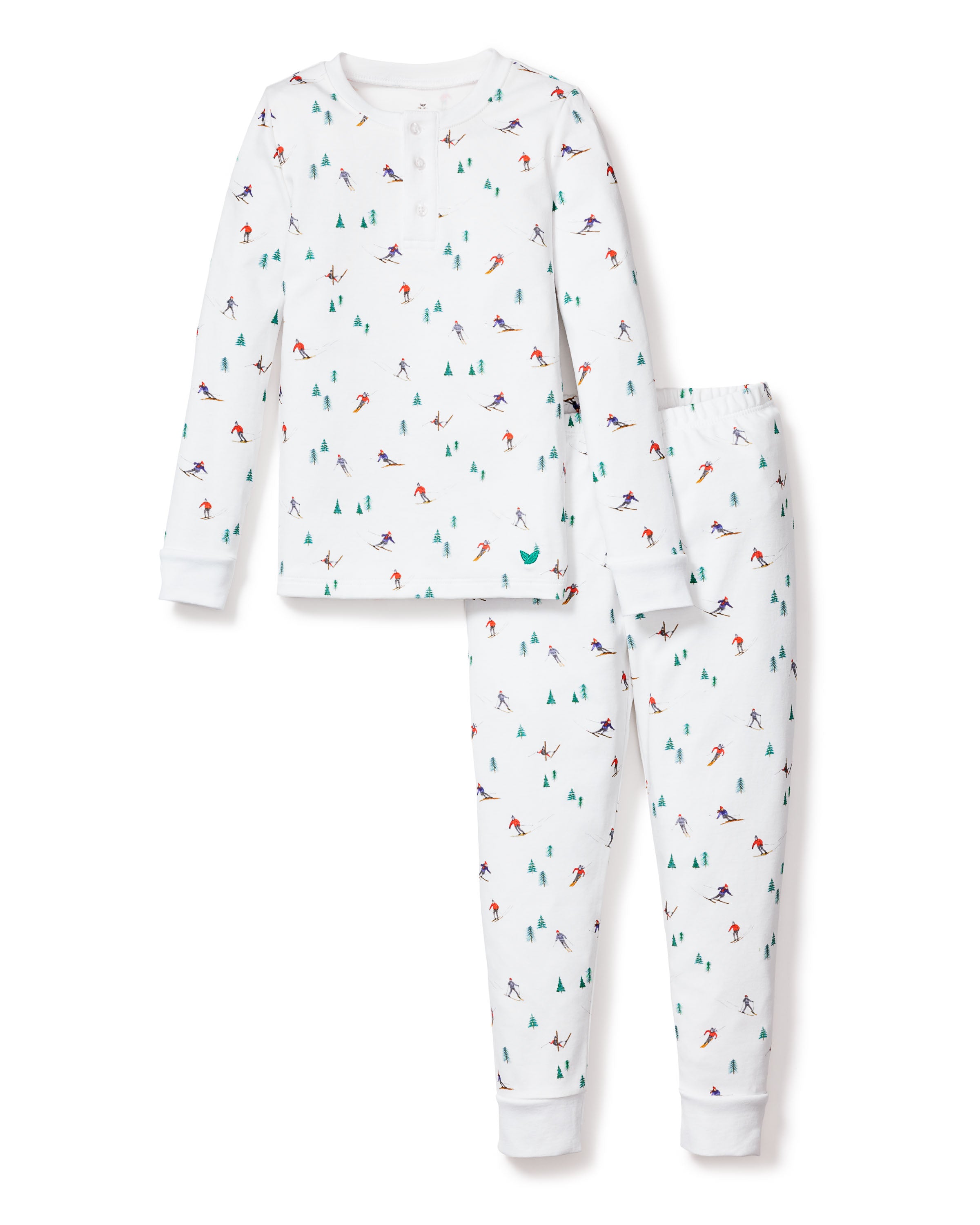 The Petite Plume Kids Pima Snug Fit Pajama Set in Après Ski features a cozy winter sports theme with small skiers and snow-covered trees on white Pima cotton. This two-piece set includes a comfy long-sleeve top and matching pants, perfect sleepwear for chilly nights.
